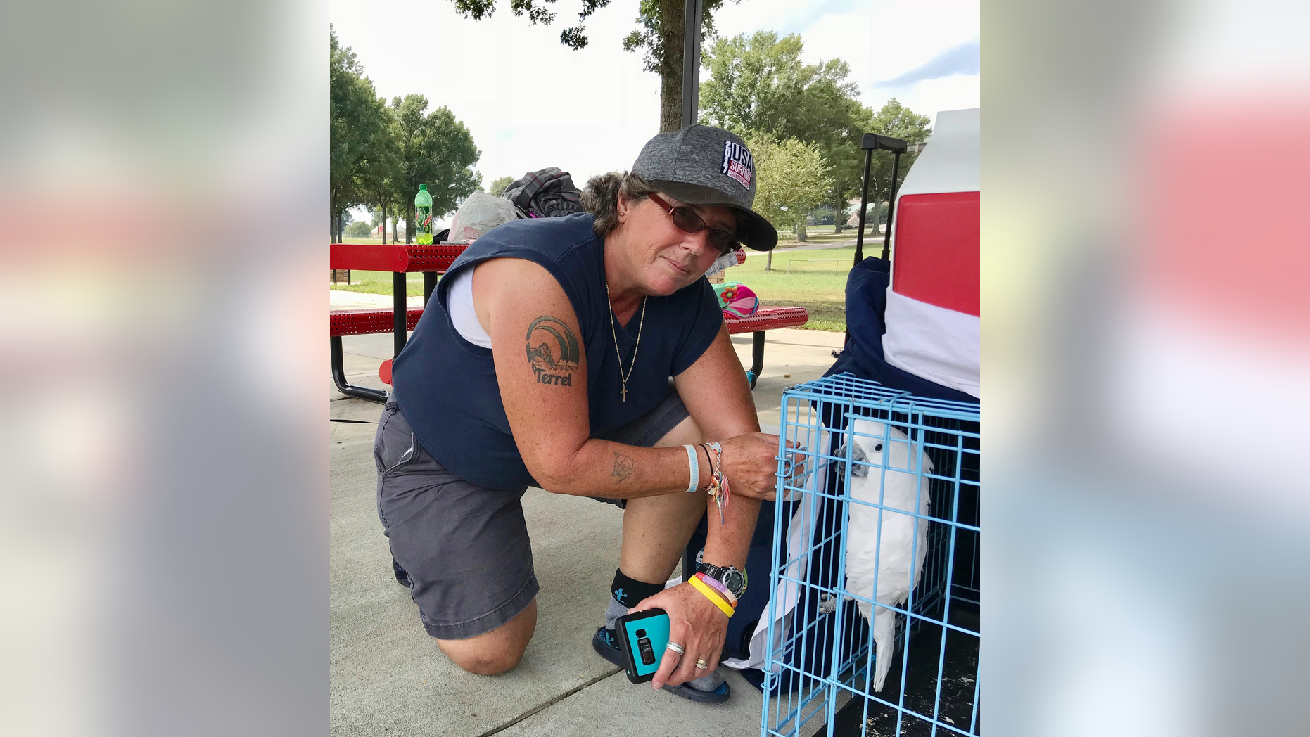 CORRECTS NAME TO LISA, NOT MELODY - Lisa Rawson looks over the possessions she grabbed from her first-floor apartment in Myrtle Beach, S.C., which are now spread out at a campground at the Atlanta Motor Speedway, and her two dogs and a cockatoo Wednesday, Sept. 12, 2018 in Hampton, Ga. She had a tire blow-out in her minivan before arriving around 3 a.m. Wednesday at the speedway, which has invited hurricane evacuees to stay at its vast campgrounds. (AP Photo/Jeff Martin)