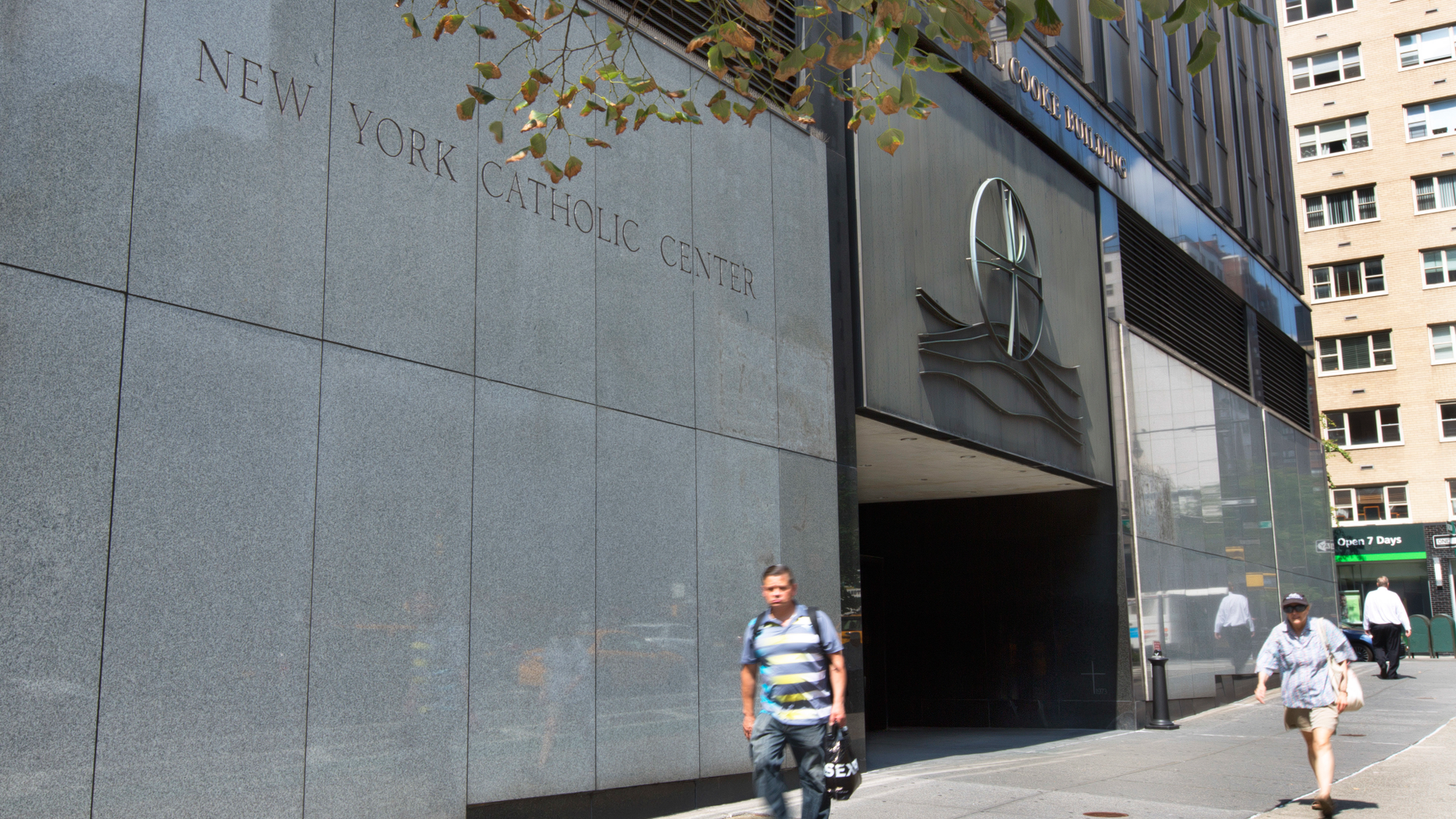 People pass the Archdiocese of New York, in New York, Thursday, Sept. 6, 2018. New York Attorney General Barbara Underwood subpoenaed all eight Roman Catholic dioceses in the state Thursday as part of a broadening civil investigation into the handling of sex abuse allegations by church leaders. (AP Photo/Richard Drew)