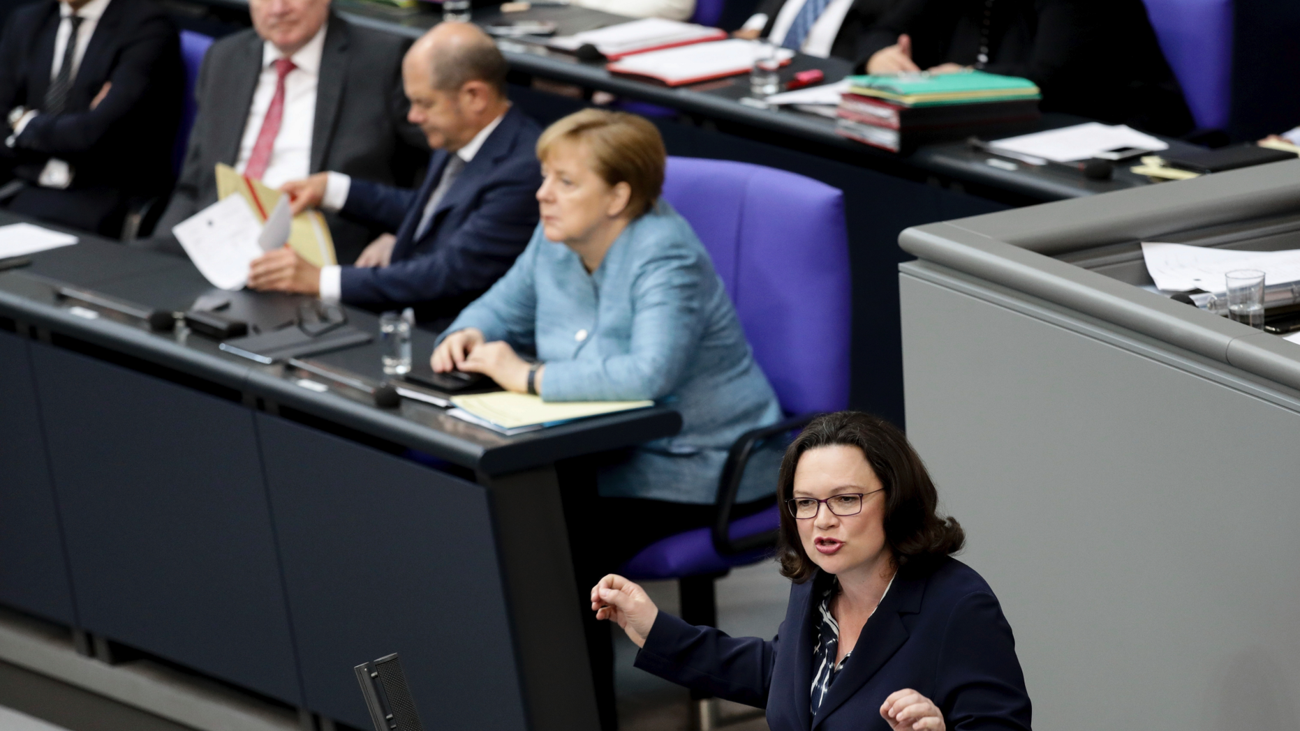 FILE - In this May 16, 2018 file photo Chair of the Social Democratic Party (SPD), Andrea Nahles, right, speaks at the plenary session of the German Bundestag in the Reichstags building in front of Foreign Minister Heiko Maas, Interior Minister Horst Seehofer, Finance Minister Olaf Scholz and German Chancellor Angela Merkel, from left, in Berlin. A decision to remove Germany’s spy chief after he appeared to downplay recent far-right protests but give him a new government job is causing discontent in Chancellor Angela Merkel’s government. (Kay Nietfeld/dpa via AP)