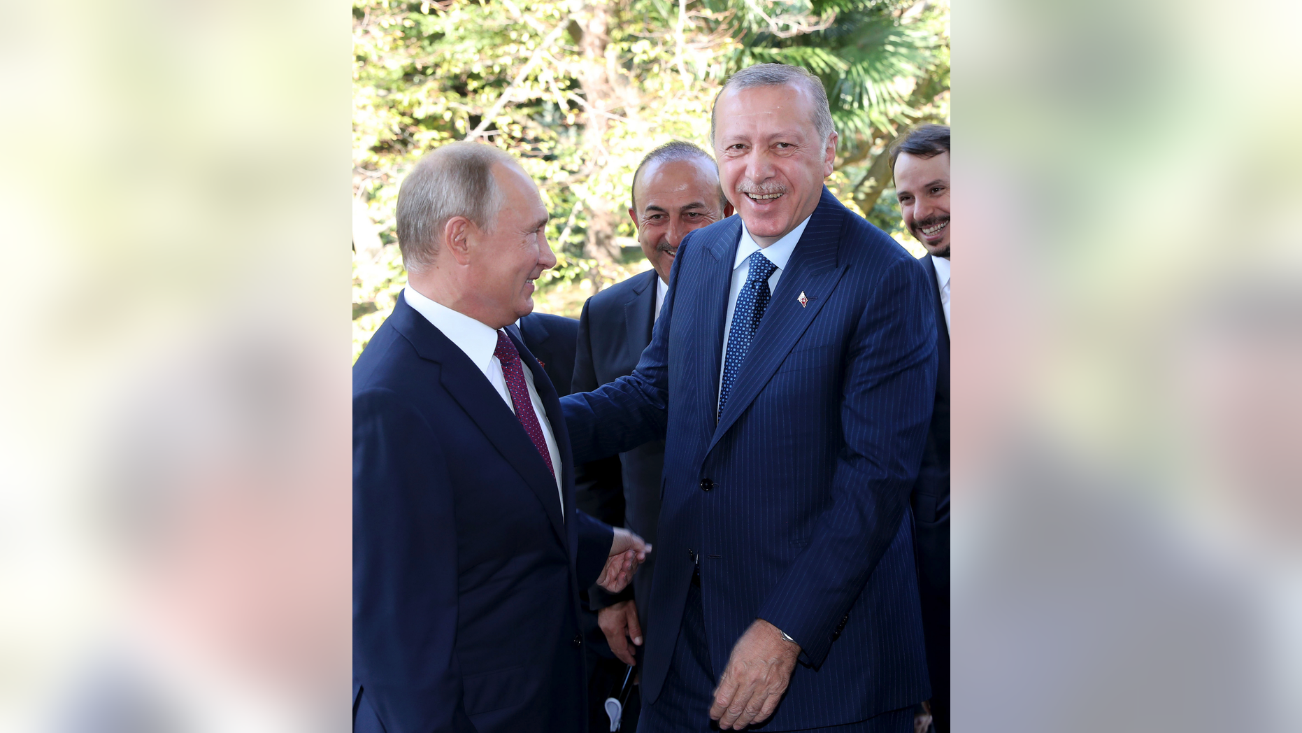 Russian President Vladimir Putin, left, welcomes Turkey's President Recep Tayyip Erdogan, prior to their talks at the Bocharovy Ruchei residence, in Sochi, Russia, Monday, Sept. 17, 2018. The leaders of Russia and Turkey agreed Monday to establish a demilitarized zone in Syria's Idlib region. (Presidential Press Service via AP, Pool)