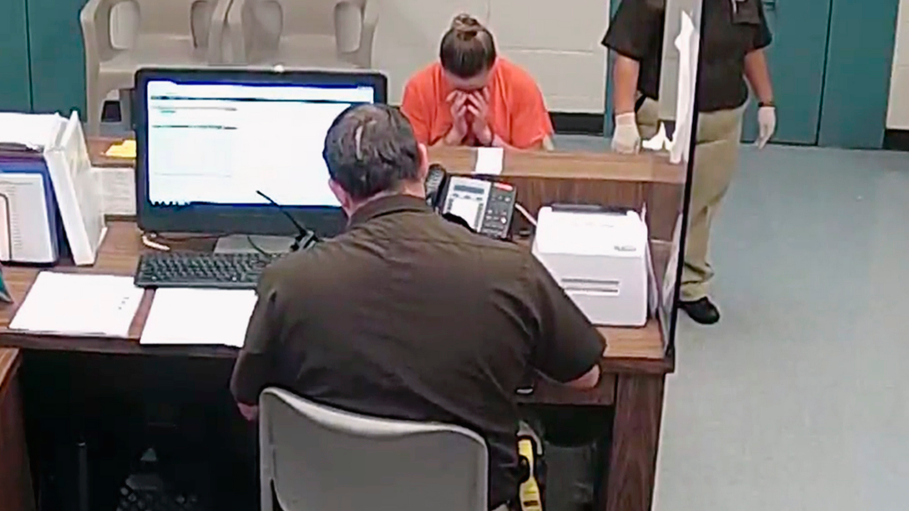 This photo from video released Thursday, Sept. 13, 2018, by the Kaufman County Sheriff's Office in Kaufman, Texas, shows Dallas police Officer Amber Guyger getting booked after turning herself in Sunday, Sept. 9 following the fatal shooting of Botham Jean in his own apartment. Guyger was arrested manslaughter and has since been released on bond. (Kaufman County Sheriff's Office Jail via AP)