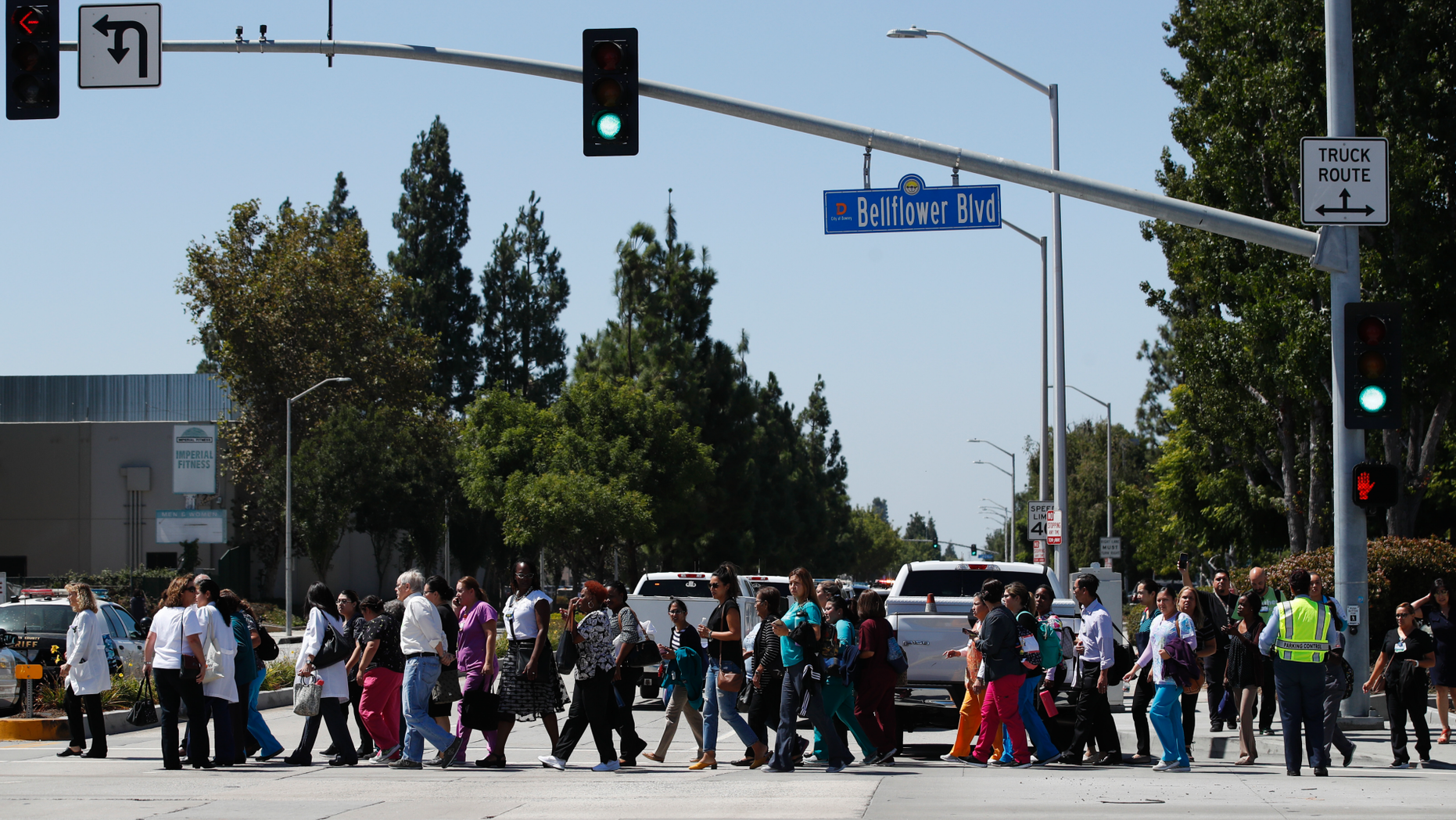 People are escorted out of Kaiser Permanente Downey Medical Center, following reports of someone with a weapon at the facility in Downey, Calif., Tuesday, Sept. 11, 2018. Authorities said an armed man who hurled a chair through a window at the facility was taken into custody and a handgun was recovered, but there’s no evidence that he fired any shots. (AP Photo/Jae C. Hong)