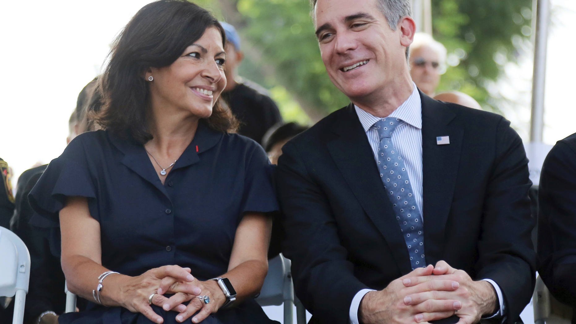 Paris Mayor Anne Hidalgo and Los Angeles Mayor Eric Garcetti speaks during a ceremony marking the 17th anniversary of the Sept. 11, 2001 terrorist attacks on America, at the Los Angeles Fire Department's training center Tuesday, Sept. 11, 2018. The mayors of Paris and Los Angeles met Tuesday ahead of a global climate summit to memorialize the victims of the 9/11 attacks on the U.S., and to talk about the commonalities between the two cities amid an increasingly divided world. The mayors then helped pack lunches for the needy. (AP Photo/Reed Saxon)