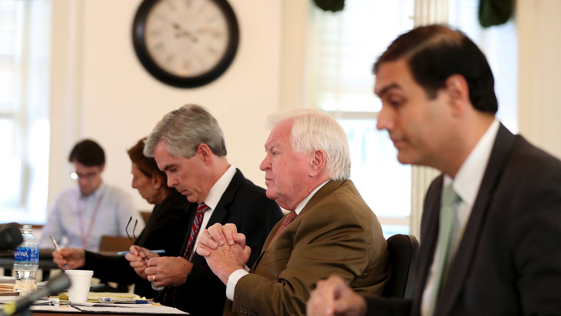 Martin P. Duffey, left, Christopher C. Fallon Jr., center, who are lawyers for Johnny Bobbitt, and Ernest E. Badway, right, who is the lawyer for the Kate McClure and Mark D'Amico, listen during a hearing on missing funds in the Johnny Bobbitt case in the Olde Historic Courthouse in Mt. Holly, NJ, Wednesday, Sept. 5, 2018. McClure and D'Amico are accused of mismanaging the money raised for Bobbitt. (David Maialetti/The Philadelphia Inquirer via AP, Pool)
