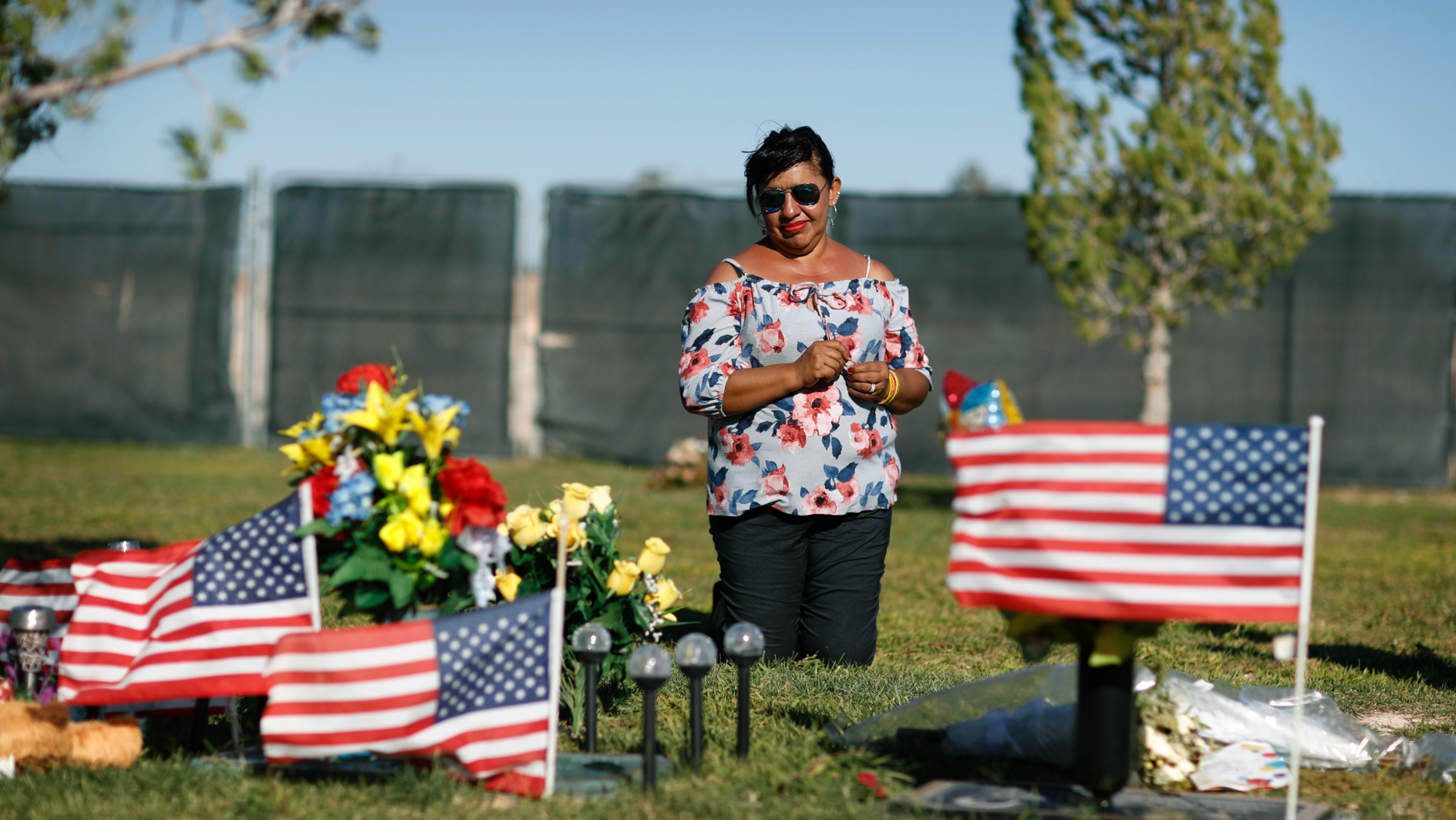 Angelica Cervantes kneels at her son Erick Silva's grave Saturday, Sept. 29, 2018, in Las Vegas. Silva was one of 58 people killed Oct. 1, 2017, in the deadliest mass shooting in modern U.S. history. Silva was working as a security guard at the Route 91 Harvest Festival and was shot while helping people climb over a barricade to escape the gunfire. (AP Photo/John Locher)