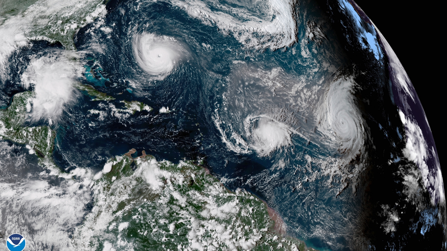 CORRECTS DATE TO SEPT. 11, NOT 1 - This enhanced satellite image made available by NOAA shows Tropical Storm Florence, upper left, in the Atlantic Ocean on Tuesday, Sept. 11, 2018 at 3:30 p.m. EDT. At center is Tropical Storm Isaac and at right is Hurricane Helene. (NOAA via AP)