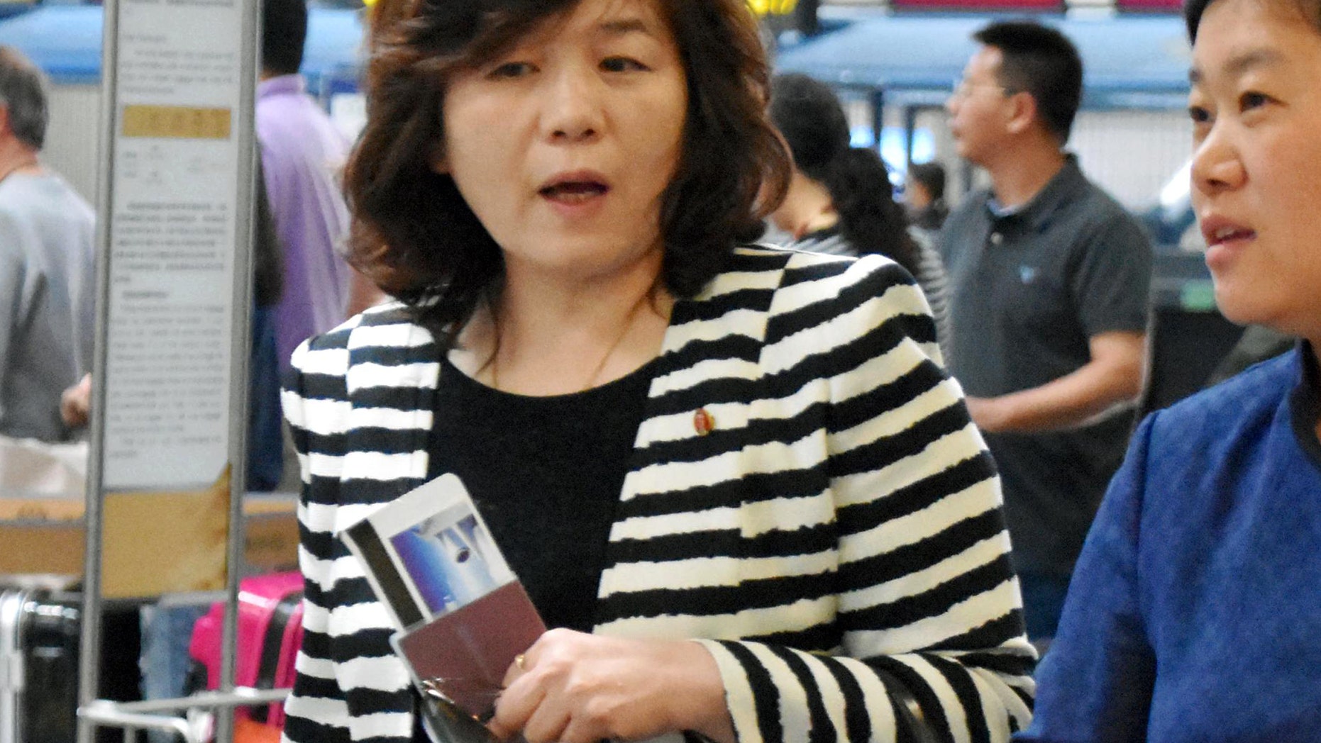 Choi Sun-hee, left, the top North Korean diplomat who handles relations with the U.S. walks prior to her departure for Pyongyang, North Korea, at Beijing Capital International Airport in Beijing Saturday, May 13, 2017. Choi said Pyongyang would be willing to meet with the Trump administration for negotiations "if the conditions are set," briefly to reporters en route to Pyongyang. She was traveling from Norway, where she led a delegation that held an informal meeting with U.S. experts. (Kyodo News via AP)