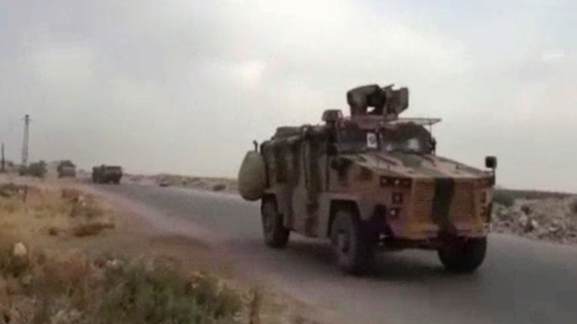 This frame grab from video provided by Central Station for Turkish Intervention, an activist-operated media group monitoring Turkish activities in Syria, that is consistent with independent AP reporting, shows a Turkish military convoy heading to some of the 12 Turkish observations points that ring Idlib, Syria, Thursday, Sept. 13, 2018. Turkey sent in military reinforcements Thursday to beef up its positions inside Syria's last rebel bastion Idlib, activists reported, even as the Turkish defense minister said Ankara is still trying with Russia and Iran to prevent a humanitarian tragedy in the case of a threatened Syrian government offensive. (Central Station for Turkish Intervention, via AP)
