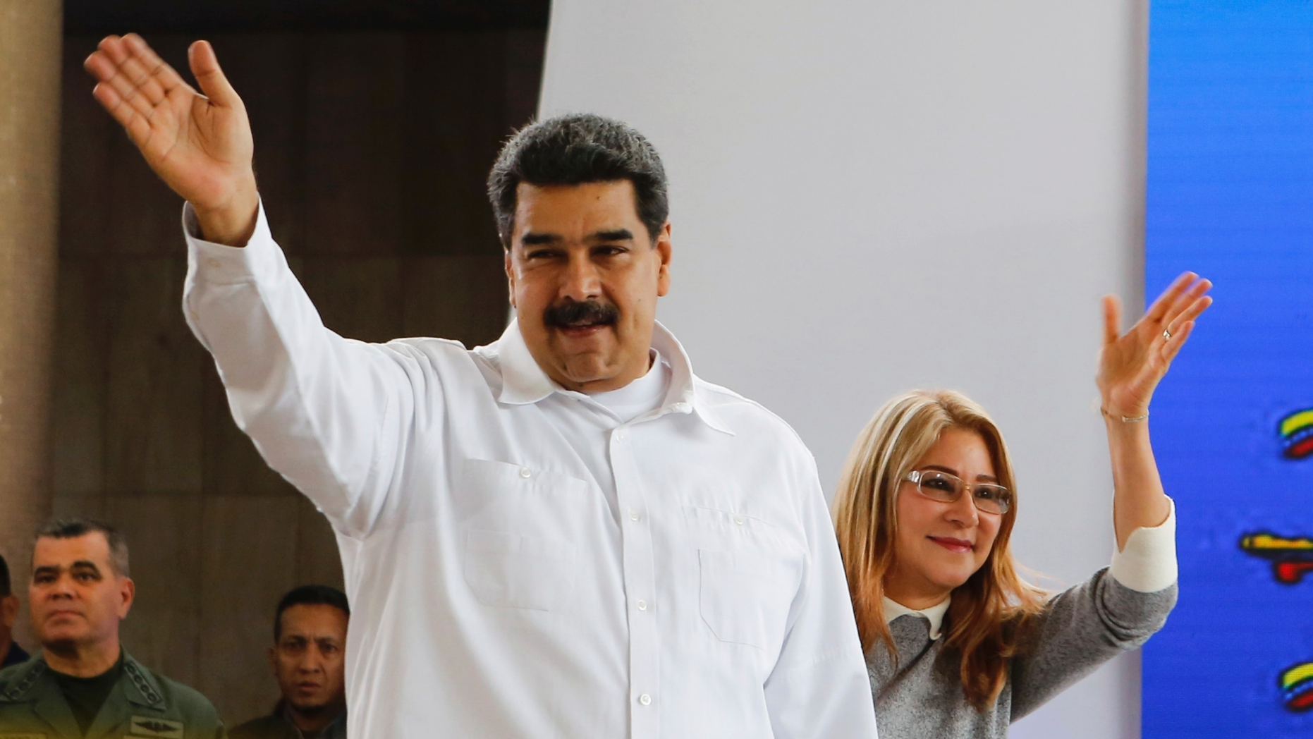 In this photo released by the Miraflores Press Office, Venezuela's President Nicolas Maduro, left, and his wife Cilia Flores greet supporters upon their arrival to a meeting with Colombian citizens that reside in Venezuela, In Caracas, Venezuela, Tuesday, Sept. 25, 2018. The Trump administration has slapped financial sanctions on four members of Venezuelan President Nicolas Maduro's inner circle, including his wife and the nation's vice president, on allegations of corruption.