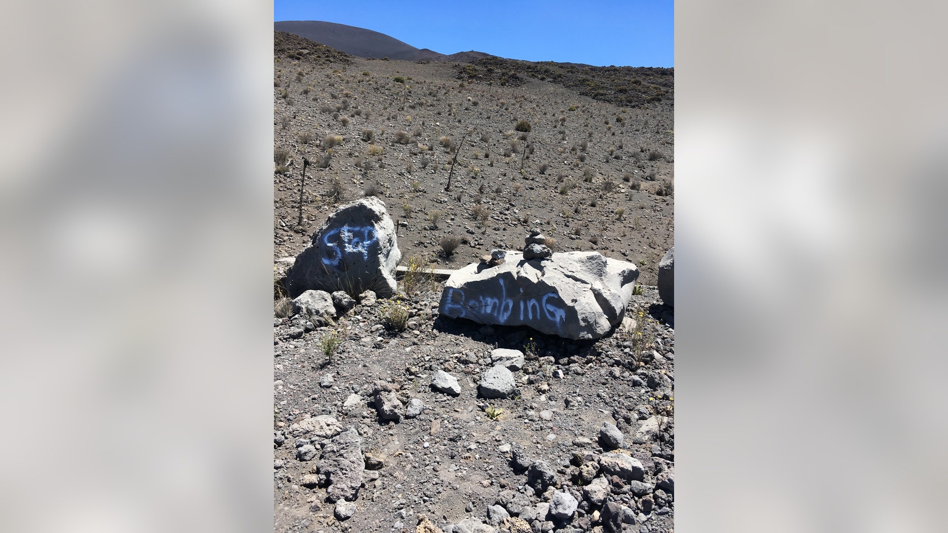 This undated photo provided by the Hawaii Department of Land and Natural Resources shows graffiti within a protected area on one of Hawaii's most revered mountains in the Mauna Kea Ice Age Reserve. The department said the graffiti was found on April 28, 2017, and authorities are asking for the public's help in finding out who painted the graffiti. (Hawaii Department of Land and Natural Resources via AP)