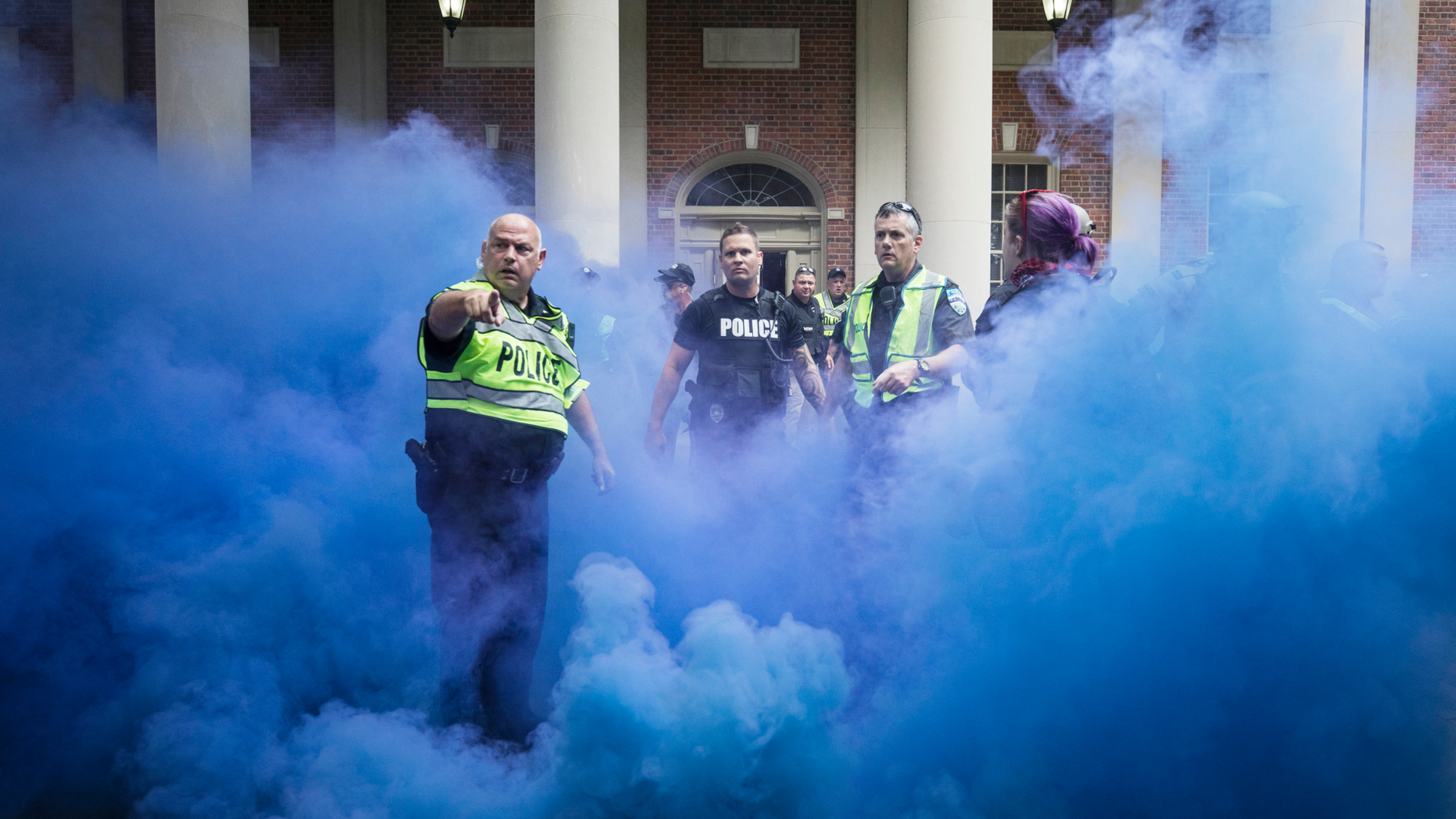 Police deploy smoke bombs into a crowd to disperse protesters after making arrests on the campus of the University of North Carolina campus in Chapel Hill, N.C., on Saturday, Sept. 8, 2018. Supporters and opponents of the Silent Sam statue faced off again late Saturday afternoon on the UNC campus, yelling at each other at the base where the Confederate monument was toppled last month. (Julia Wall/The News & Observer via AP)