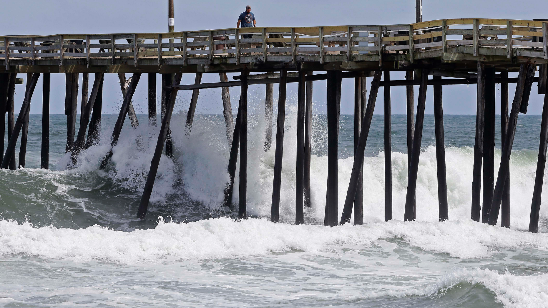 Waves crash under a pier in Kill Devil Hills, N.C., Wednesday, Sept. 12, 2018, as Hurricane Florence approaches the east coast. (AP Photo/Gerry Broome)