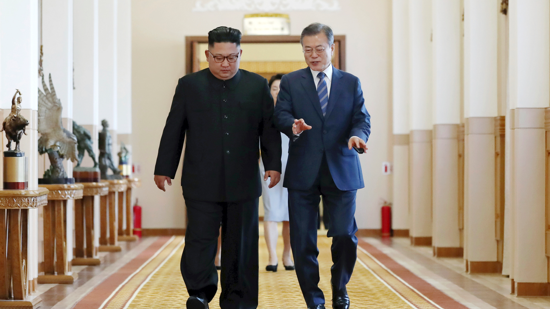 South Korean President Moon Jae-in, right, and North Korean leader Kim Jong Un walk together at the Paekhwawon State Guesthouse in Pyongyang, North Korea, Wednesday, Sept. 19, 2018. Moon and Kim have announced a sweeping set of agreements after their second day of talks in Pyongyang. It includes a promise by Kim to permanently dismantle the North's main nuclear complex if the United States takes corresponding measures, the acceptance of international inspectors to monitor the closing of a key missile test site and launch pad and a vow to work together to host the Summer Olympics in 2032.(Pyongyang Press Corps Pool via AP)