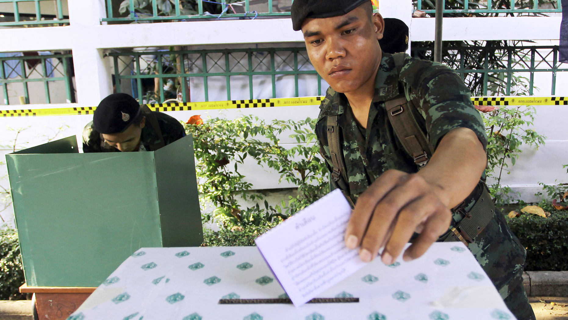 FILE - In this Feb. 2, 2014, file photo, a Thai soldier casts his vote during the general election at a polling station in Bangkok, Thailand. Thailand has taken another step toward holding elections next year in 2019 by easing some restrictions on political activities to allow parties to conduct basic functions, but they are still barred from campaigning. (AP Photo/Apichart Weerawong, File)