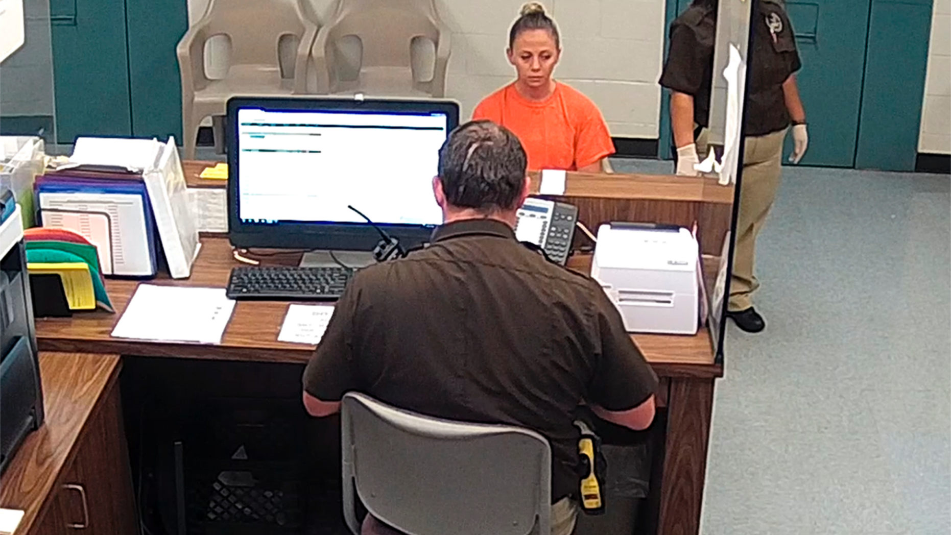 This photo from video released Thursday, Sept. 13, 2018, by the Kaufman County Sheriff's Office in Kaufman, Texas, shows Dallas police Officer Amber Guyger getting booked after turning herself in Sunday, Sept. 9 following the fatal shooting of Botham Jean in his own apartment. Guyger was arrested manslaughter and has since been released on bond. (Kaufman County Sheriff's Office Jail via AP)