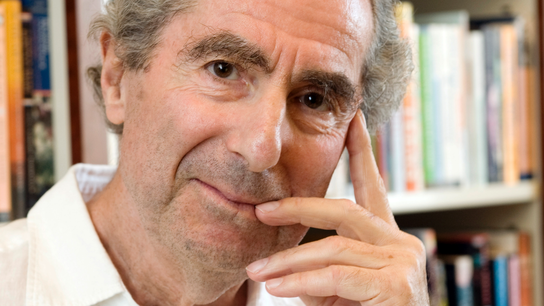 FILE - In this Sept. 8, 2008, file photo, author Philip Roth poses for a photo in the offices of his publisher, Houghton Mifflin, in New York. Friends and admirers will gather Tuesday, Sept. 25, 2018, at the New York Public Library for a tribute to Philip Roth, who died in May. (AP Photo/Richard Drew, File)