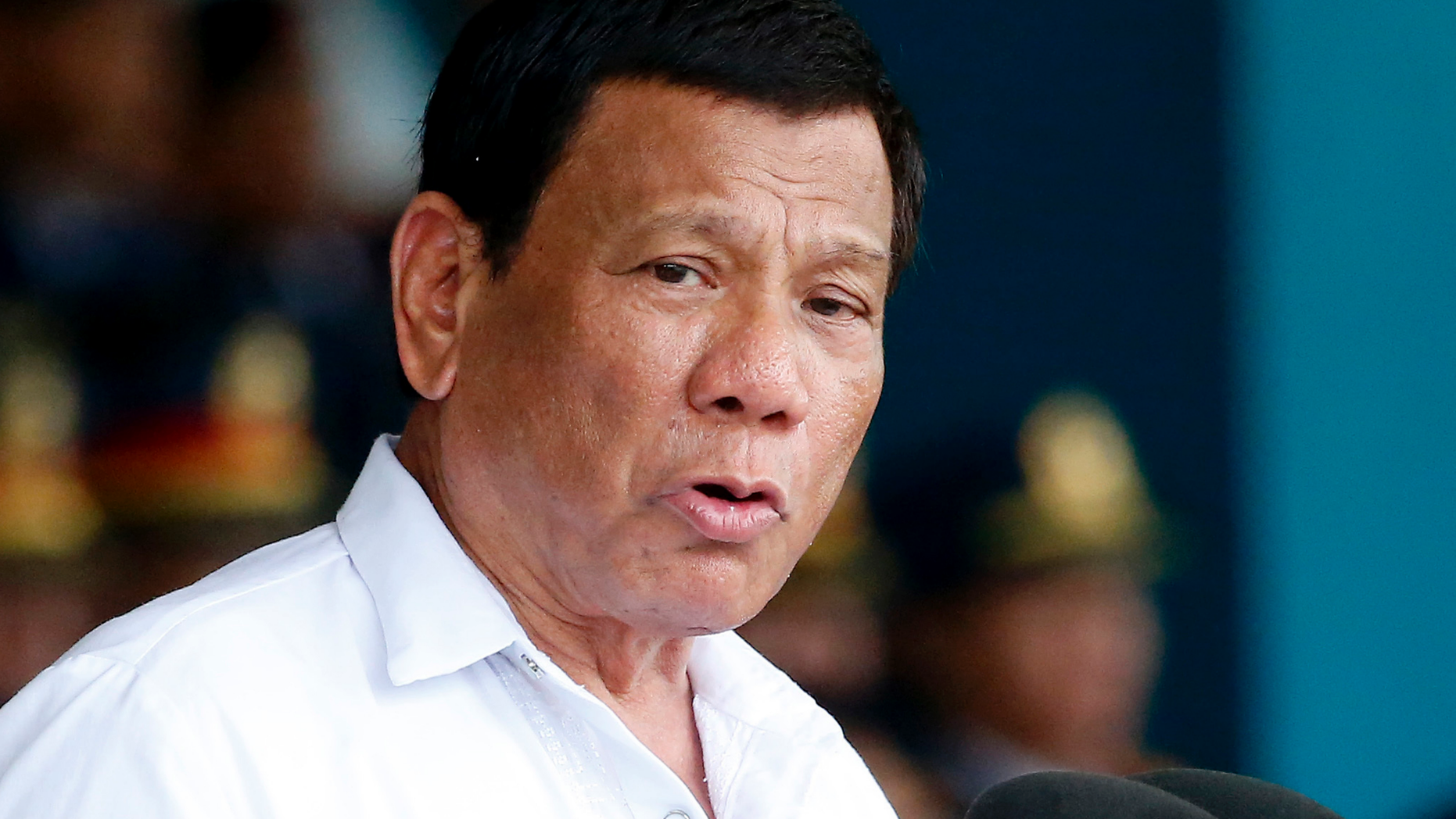 FILE - In this Wednesday, Aug. 8, 2018, file photo, President Rodrigo Duterte gestures while addressing police force to mark the 117th Philippine National Police Service anniversary Quezon city northeast of Manila, Philippines. Rights activists say the Philippine president has acknowledged he sanctioned extrajudicial killings in his brutal drug war, but his aides argue that his words were taken out of context. (AP Photo/Bullit Marquez, File)