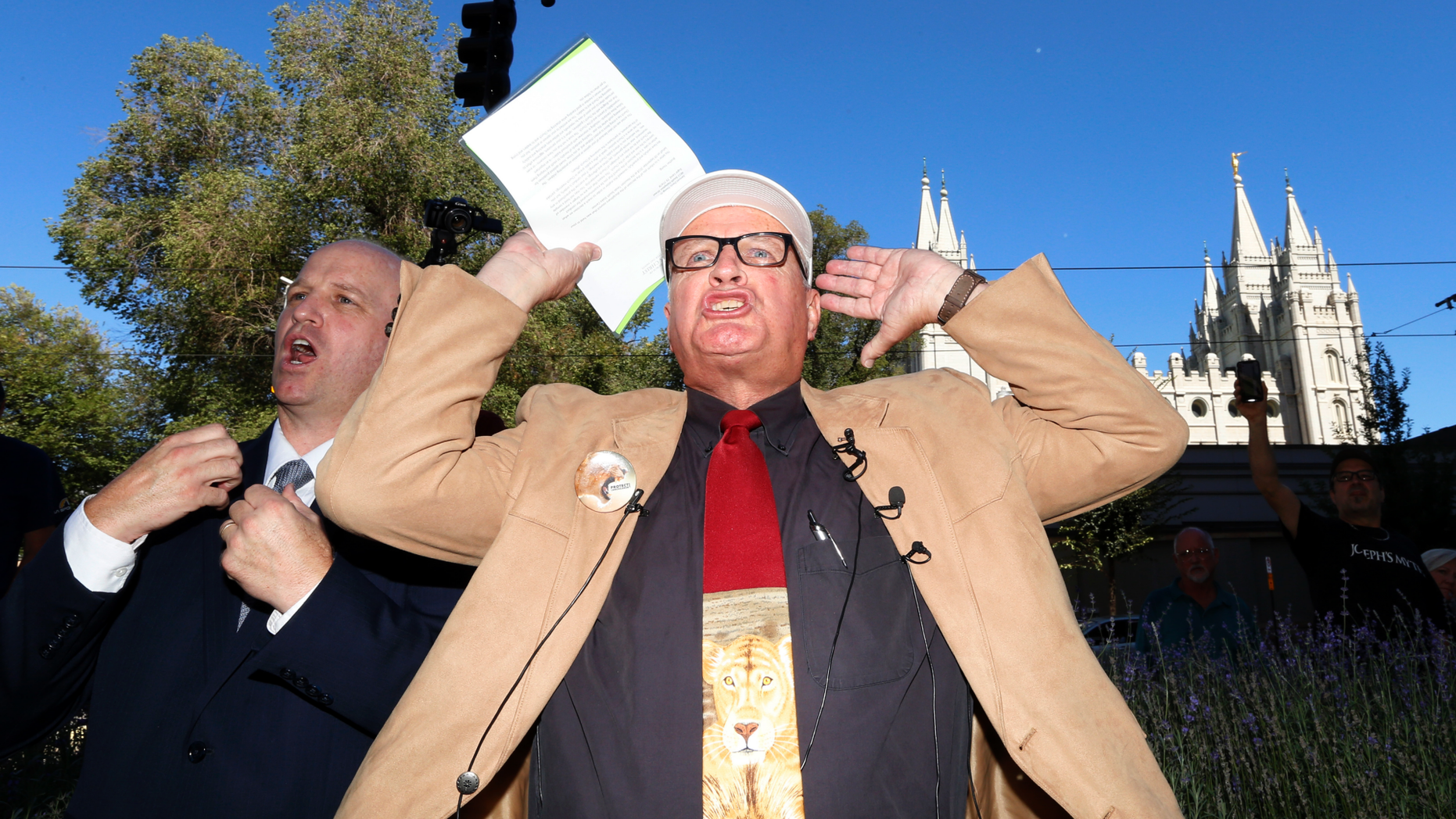 Sam Young reacts after reading a letter detailing his excommunication proceedings from the Mormon Church during a news conference Sunday, Sept. 16, 2018, near Temple Square, in Salt Lake City. Young, a Mormon man who led a campaign criticizing the church's practice of allowing closed-door, one-on-one interviews of youth by lay leaders has been kicked out of the faith. Young, a 65-year-old lifelong Mormon, becomes the third high-profile member of the faith who led protests about church policy to be excommunicated in recent years. (AP Photo/Rick Bowmer)