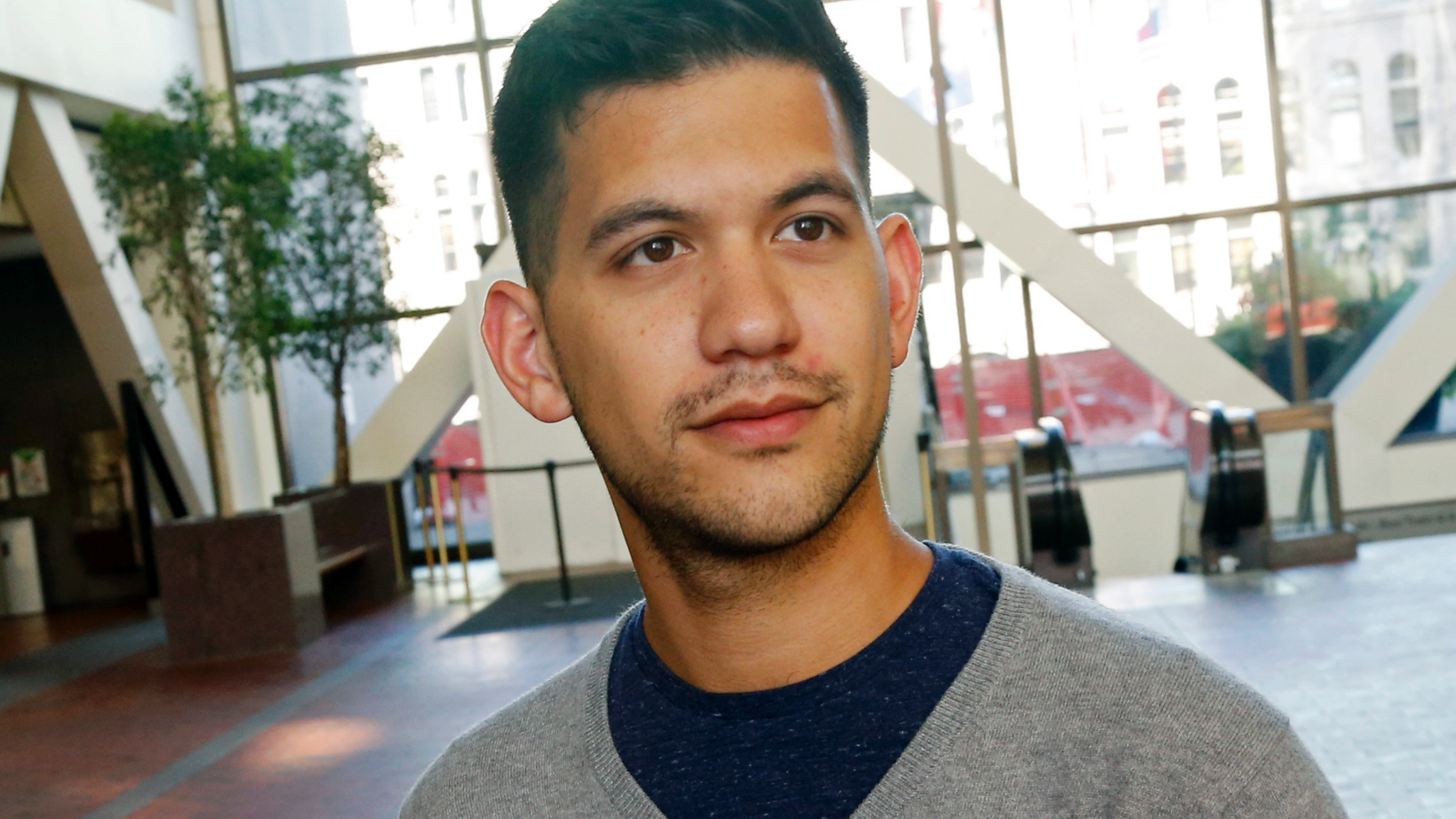 In this Friday, Sept. 7, 2018 photo, Chris Damian poses in Minneapolis. Damian believes having more nuanced conversations about hard topics like sex abuse by priests and allegations of cover-ups by church leaders can bring about change. Damian, 27, has organized a group of Catholic young adults to respond to the church crisis. (AP Photo/Jim Mone)