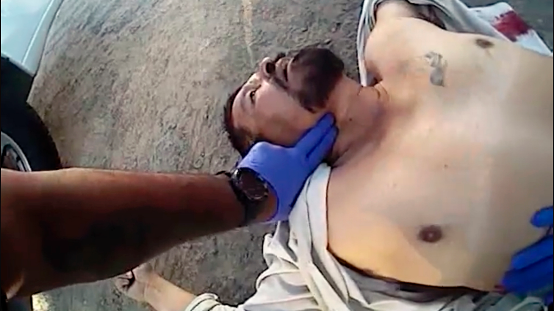 EDITORS NOTE CONTENTS - This photo from video from a deputy's body camera, provided by the Kern County, Calif., Sheriff's Office, shows officers and others treating Javier Casarez, 54, moments after he fatally shot himself, during a confrontation in Bakersfield, Calif., Wednesday, Sept. 12, 2018. Kern County Sheriff Donny Youngblood Thursday identified Cazarez as the gunman who fatally shot his ex-wife and a man at a trucking company before chasing after another man, killing him, and then driving to a home where he shot dead a father and daughter in a nearly 40-minute rampage Wednesday. (Kern County Sheriff's Office via AP)