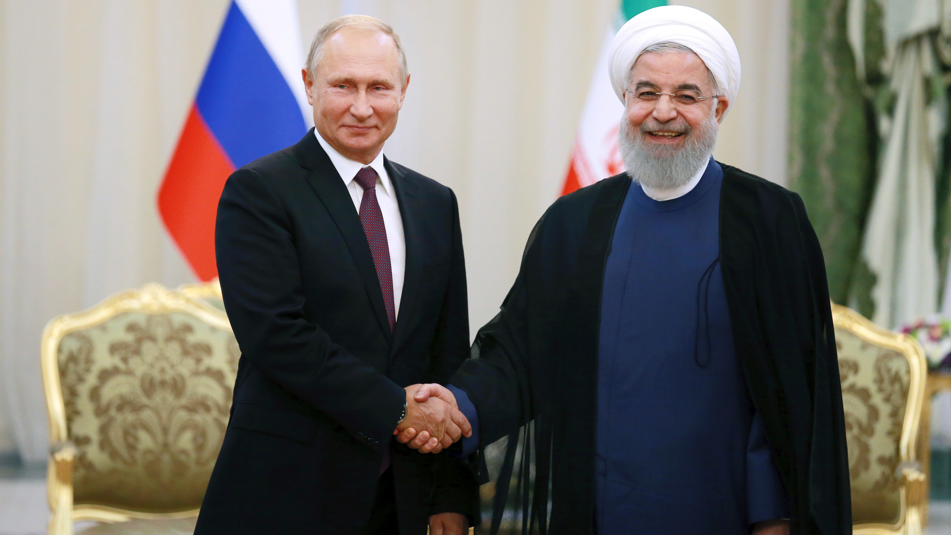 Iran's President Hassan Rouhani, right, shakes hands with Russia's President Vladimir Putin, in Tehran, Iran, Friday, after their talks, part of Russia-Iran-Turkey summit to discuss Syria, Friday Sept. 7, 2018. Putin, Erdogan and Iran's President Hassan Rouhani began a meeting Friday in Tehran to discuss the war in Syria, with all eyes on a possible military offensive to retake the last rebel-held bastion of Idlib. (AP Photo/Ebrahim Noroozi)