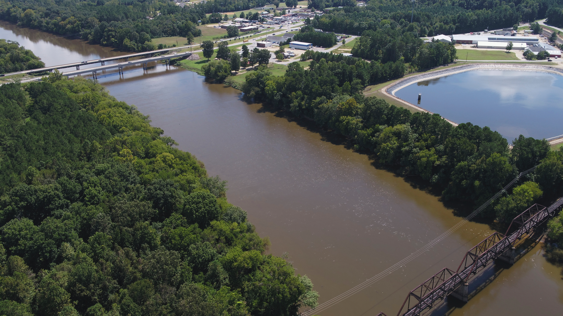 FILE - In this Tuesday afternoon, Sept. 12, 2018 file photo provided by DroneBase, an aerial view of the Cape Fear River, N.C., in Buckhorn, N.C. is shown ahead of Hurricane Florence. Record flooding is expected on North Carolina's Cape Fear River in the coming week, and signs of the coming flood are already apparent. The Cape Fear River is predicted to crest at 62 feet (nearly 19 meters) in Fayetteville on Tuesday, Sept. 18. (DroneBase via AP, File)