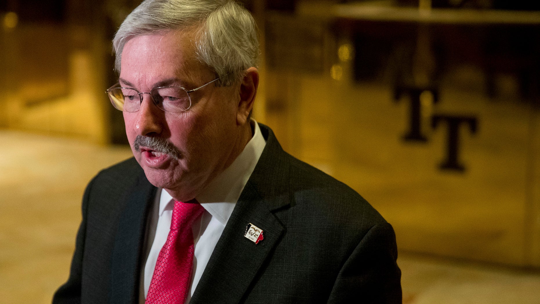 FILE - In this Dec. 6, 2016 file photo, Iowa Gov. Terry Branstad speaks to members of the media in the lobby of Trump Tower in New York. A Senate panel has approved Branstad as U.S. ambassador to China. (AP Photo/Andrew Harnik, File)