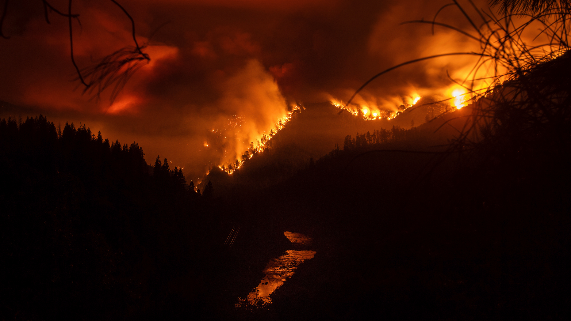 The Delta Fire burns in the Shasta-Trinity National Forest, Calif., on Wednesday, Sept. 5, 2018. Parked trucks lined more than two miles of Interstate 5 as both directions remained closed to traffic. (AP Photo/Noah Berger)