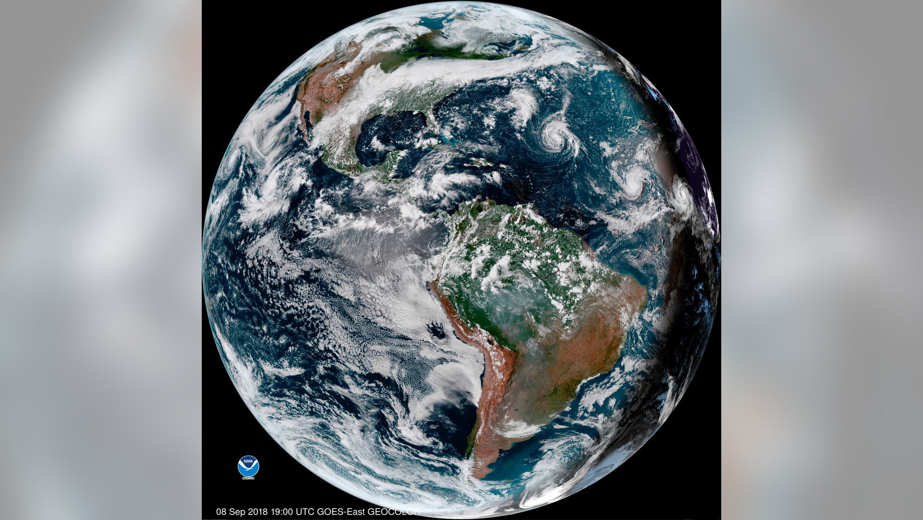 This enhanced satellite image made available by NOAA shows Tropical Storm Florence, third from right, in the Atlantic Ocean on Saturday, Sept. 8, 2018 at 3 p.m. EDT. At right, off the coast of Africa is Tropical Storm Helene, and second from right is Tropical Depression 9. (NOAA via AP)