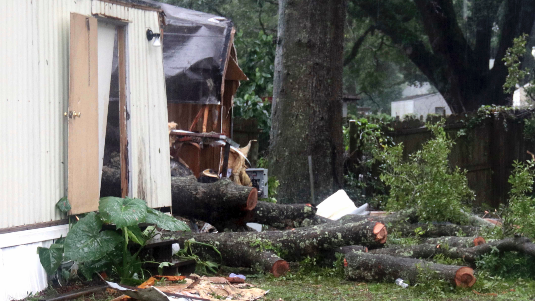 Pieces of an oak tree are seen after it fell on a mobile home killing a child in Pensacola, Fla., Wednesday, Sept. 5 2018. Tropical Storm Gordon never became a hurricane and is now a depression, dumping rain across several southern states. (Bill Kaczor via AP)