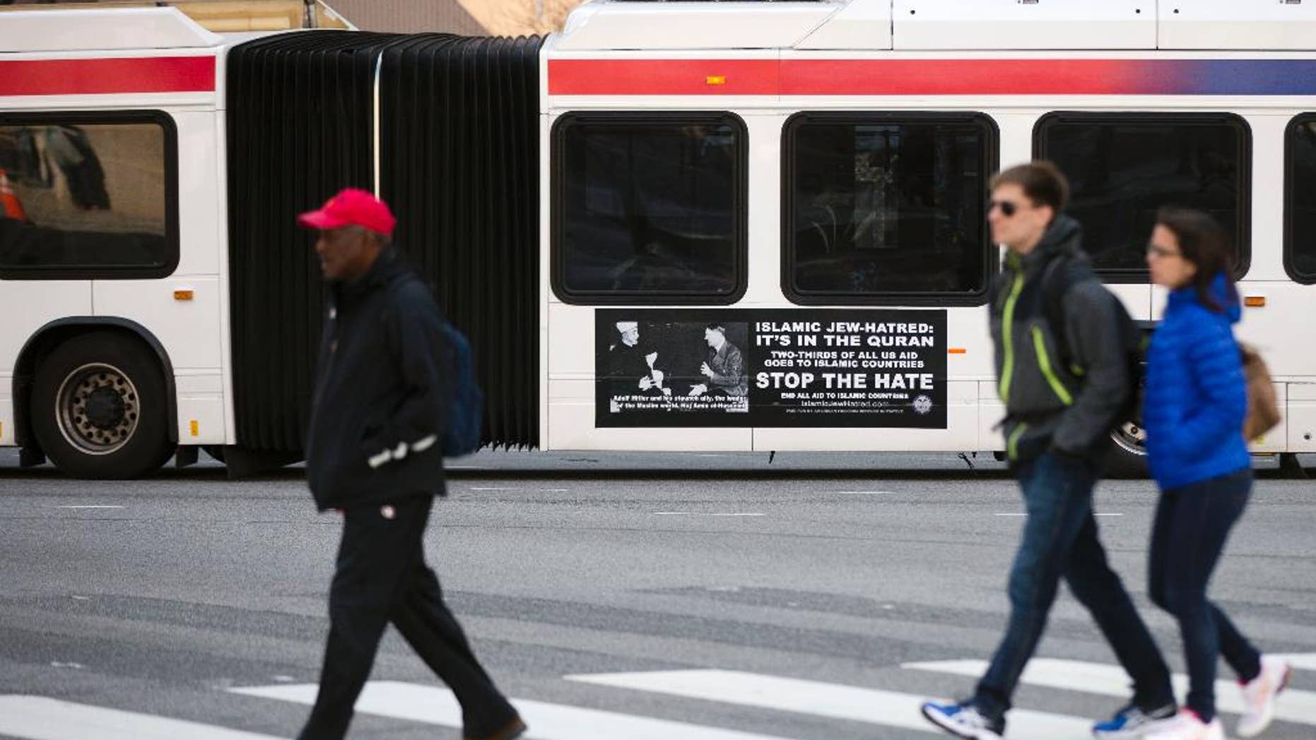 An ad from the pro-Israel American Freedom Defense Initiative is seen on an articulated Southeastern Pennsylvania Transportation Authority (SEPTA) bus featuring a 1941 photograph of Hitler and supporter Hajj Amin al-Husseini, a Palestinian Arab nationalist, Wednesday, April 1, 2015, in Philadelphia. A federal judge last month ordered SEPTA to accept the ads. The agency said last week it wouldn't appeal. (AP Photo/Matt Rourke)