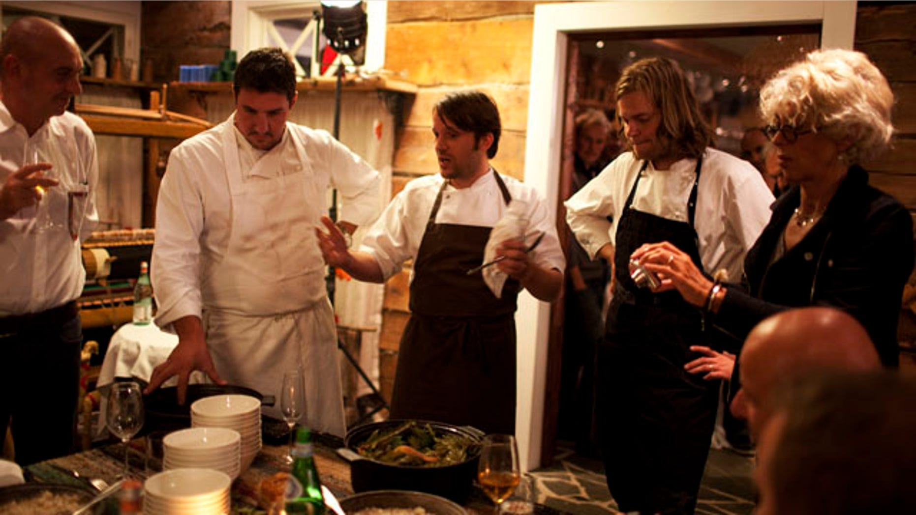 In this September 2010 photo released by Cook It Raw shows Rene Redzepi, and his team presenting the final dish on the last evening during "Cook It Raw" in Lapland, Finland. The event marked the third time in just over a year that this international group of chefs have hunted, fished and foraged together in a particular location, then prepared a meal while leaving the smallest possible footprint on the environment. (AP)