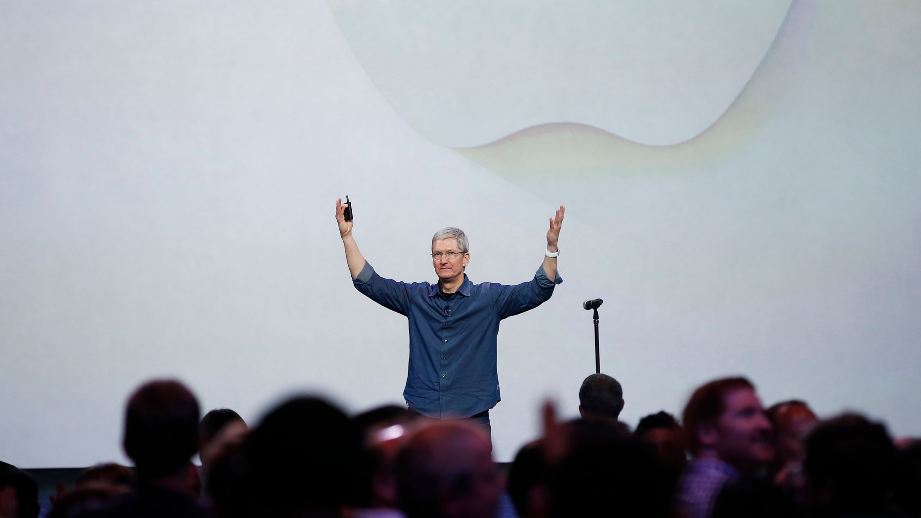 Apple CEO Tim Cook greets the audience during an Apple event announcing the iPhone 6 and the Apple Watch.