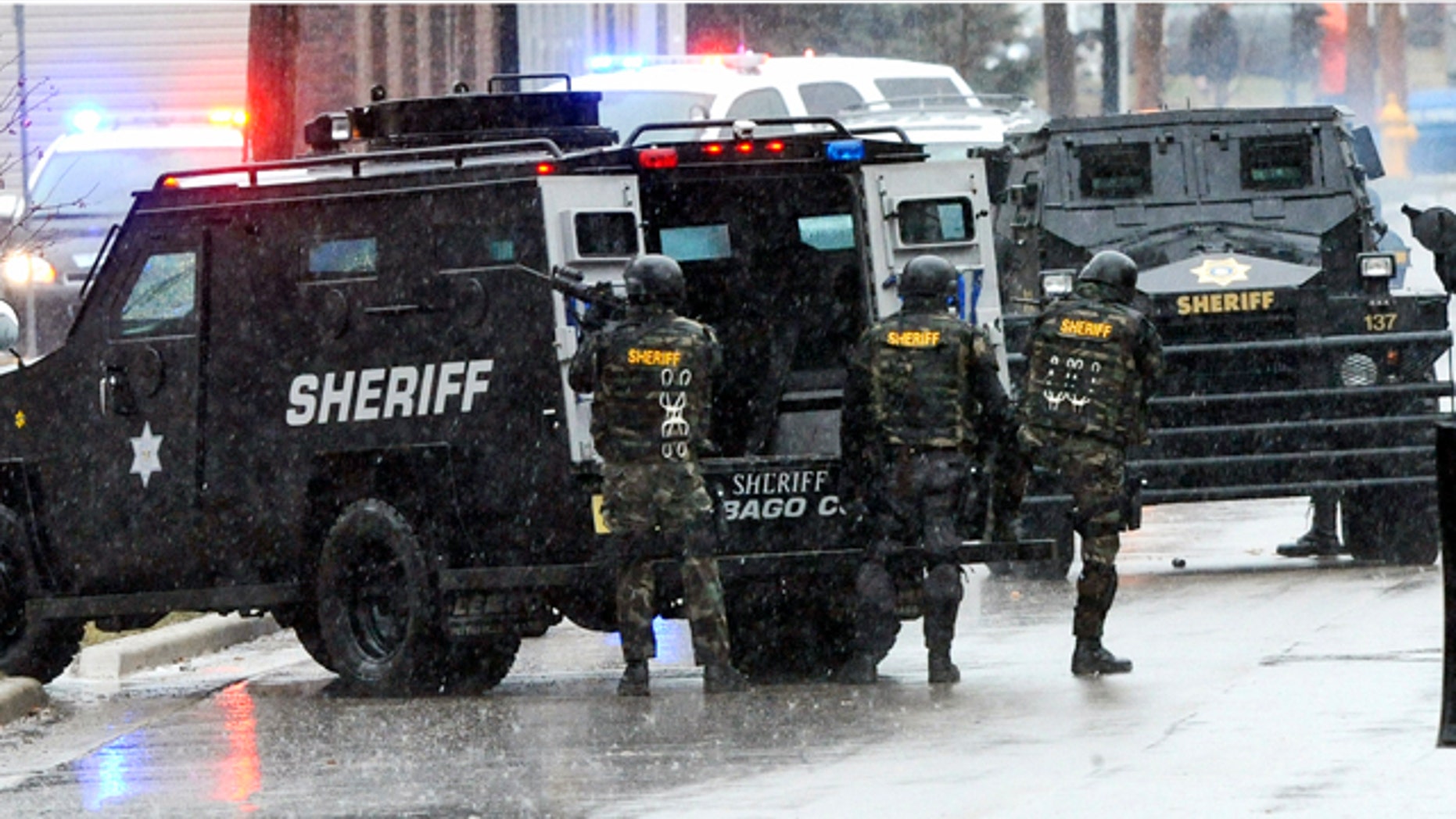 March 20, 2011: Swat team members arrive outside the home of a suspect who shot a Fond du Lac police officer