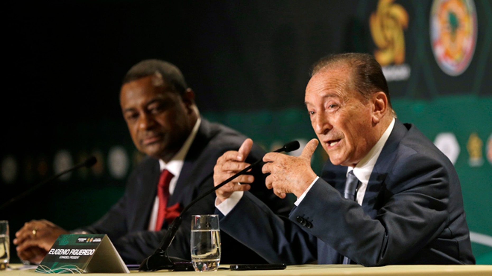 Eugenio Figueredo, right, president of CONMEBOL, the South American Football Confederation, gestures as he talks during a news conference as CONCACAF president Jeffrey Webb, left, looks on in Bal Harbour, Fla., Thursday, May 1, 2014. The United States will host the Copa America soccer tournament for the first time in 2016. The Copa America, the world's oldest intercontinental soccer tournament, will celebrate its 100th anniversary in 2016. (AP Photo/Alan Diaz)