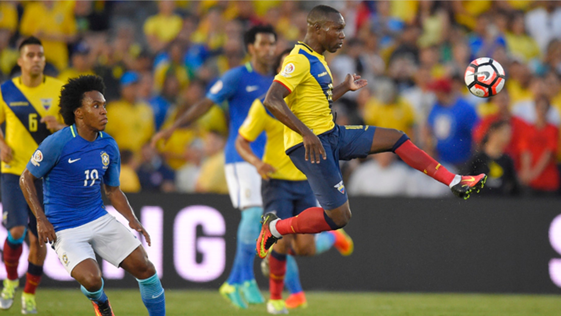 Ecuador midfielder Walter Ayovi, right, kicks the ball as Brazil midfielder Willian, left, watches during a Copa America group B soccer match at the Rose Bowl, Saturday, June 4, 2016, in Pasadena, Calif. (AP Photo/Mark J. Terrill)