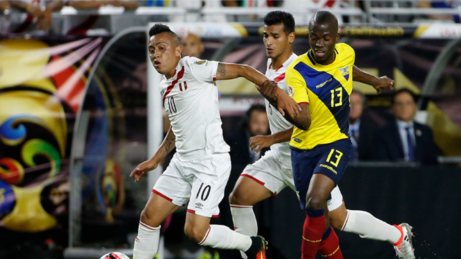 Peru's Christian Cueva dribbles the ball away from Ecuador's Enner Valencia on June 8, 2016, in Glendale, Ariz.