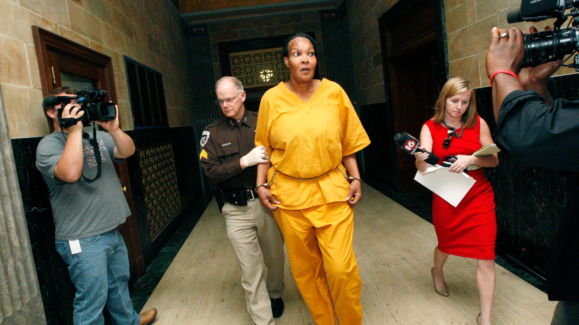 Sept. 11, 2012: Morris Garner, who also goes by the name Tracey Lynn Garner, is escorted from a Hinds County courtroom by bailiff Tony Queen in Jackson, Miss., following a bond hearing.