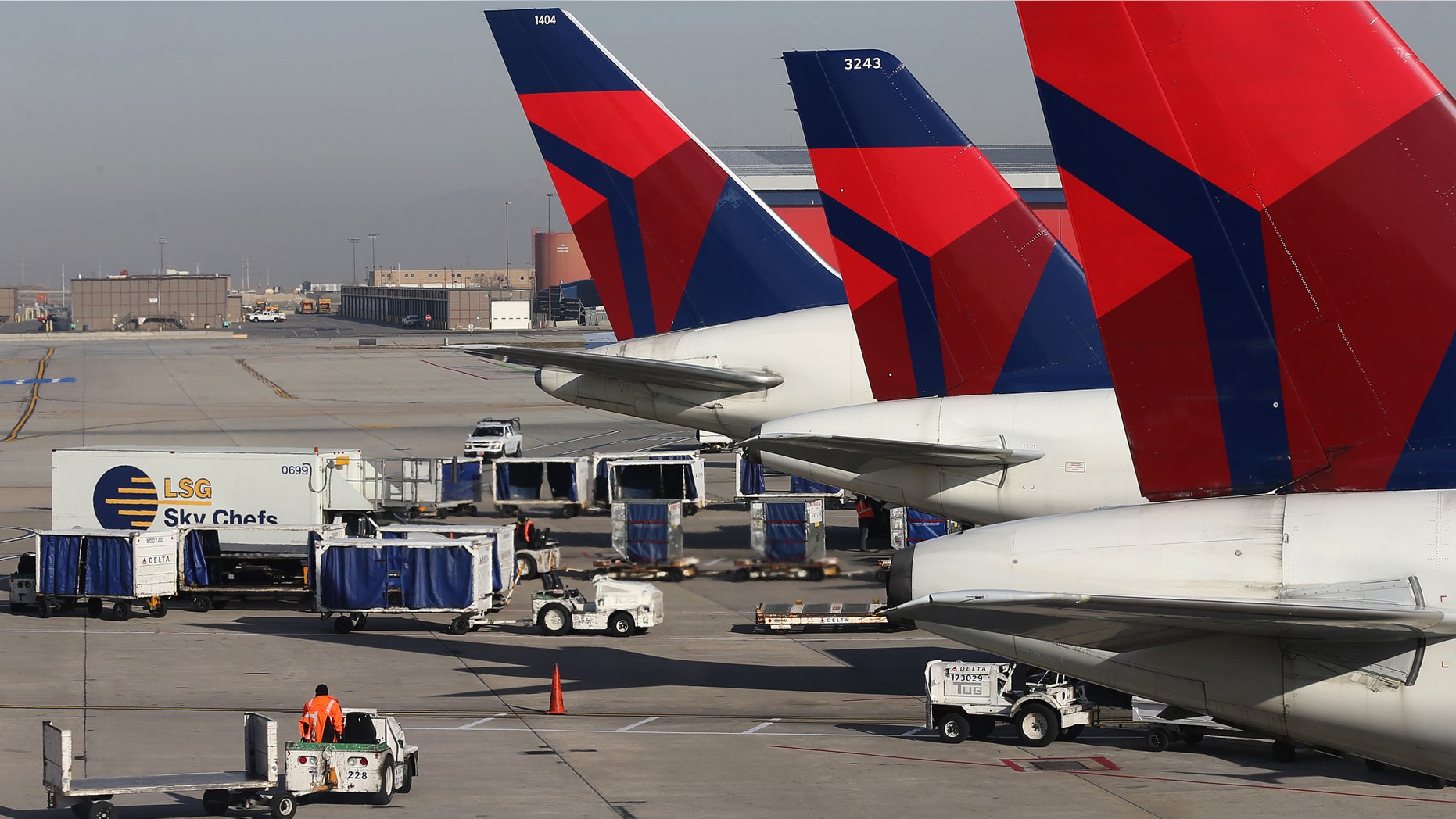SALT LAKE CITY, UT - NOVEMBER 27: Ground crew personnel service Delta planes at the Salt Lake City international Airport on November 27, 2013 in Salt Lake City, Utah. A wintry storm system that is covering much of the nation is threatening to wreak havoc on holiday travel . (Photo by George Frey/Getty Images)