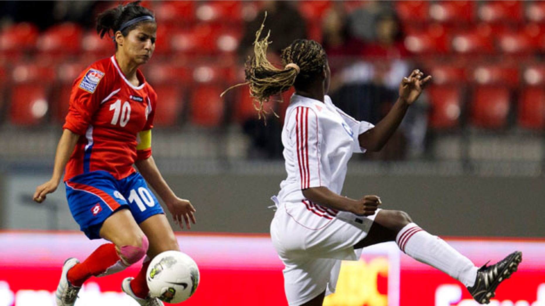 Costa Rica's Shirley Cruz (10) blocks a kick from Cuba's Jessica Alvarez Pupo, right in CONCACAF Women's Olympic qualifying soccer in Vancouver, British Columbia, Thursday, Jan. 19, 2012. Costa Rica won 2-0. (AP Photo/The Canadian Press, Jonathan Hayward)