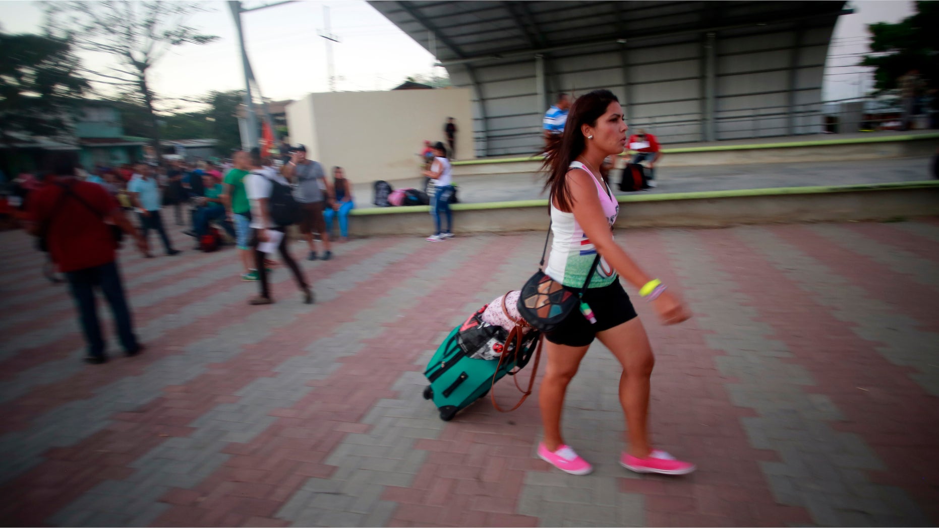 A Cuban migrant walks to the airport in La Cruz, Costa Rica, Tuesday, Jan. 12, 2016.