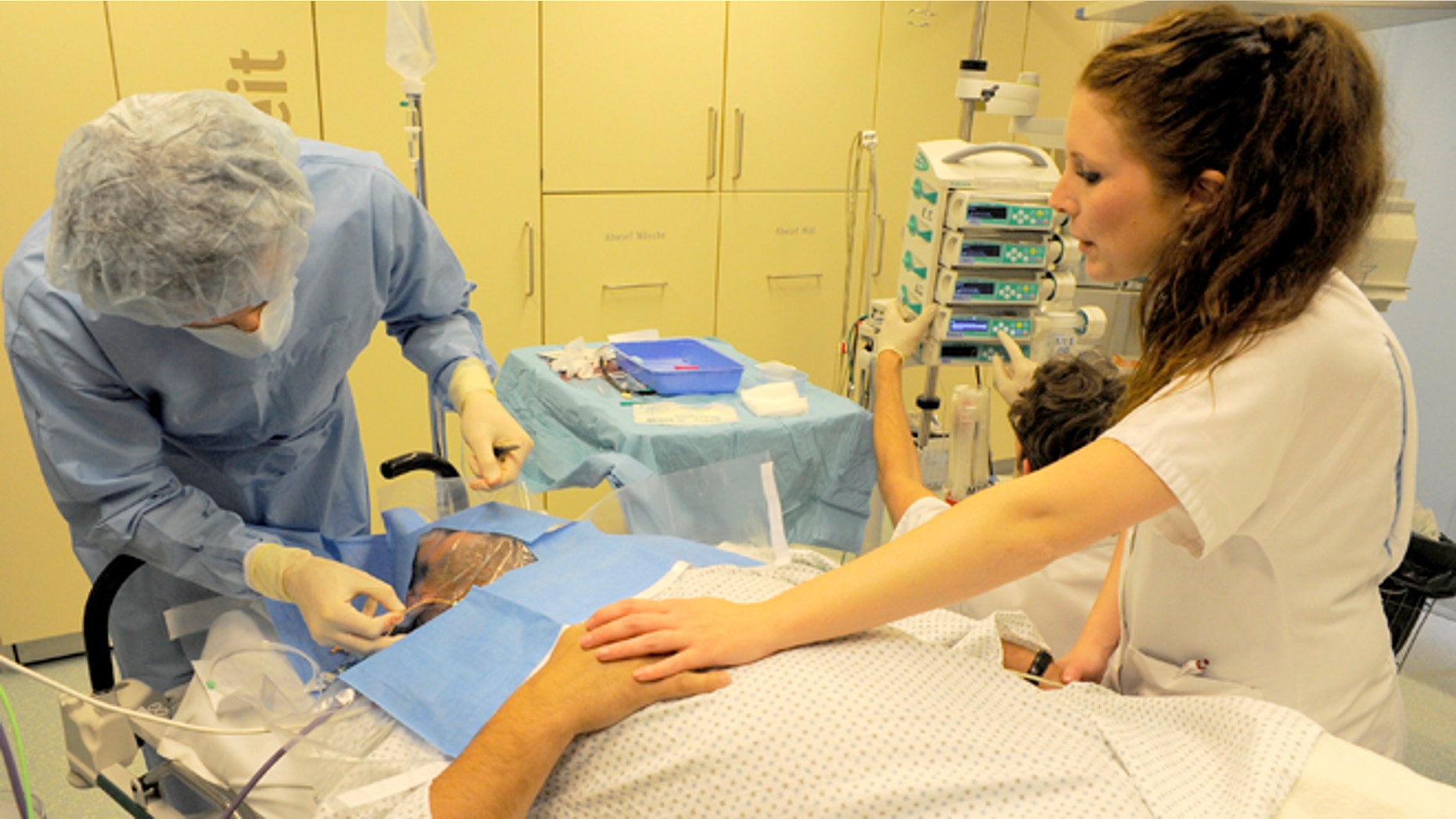 BERLIN, GERMANY - JUNE 17: A doctor and a nurse prepare a patient possibly suffering from the consequences of a heart attack at the Unfallkrankenhaus Berlin (UKB) hospital in Marzahn district on June 17, 2013 in Berlin, Germany. The UKB hospital has among the most modern emergency care services in Germany. (Photo by Theo Heimann/Getty Images)