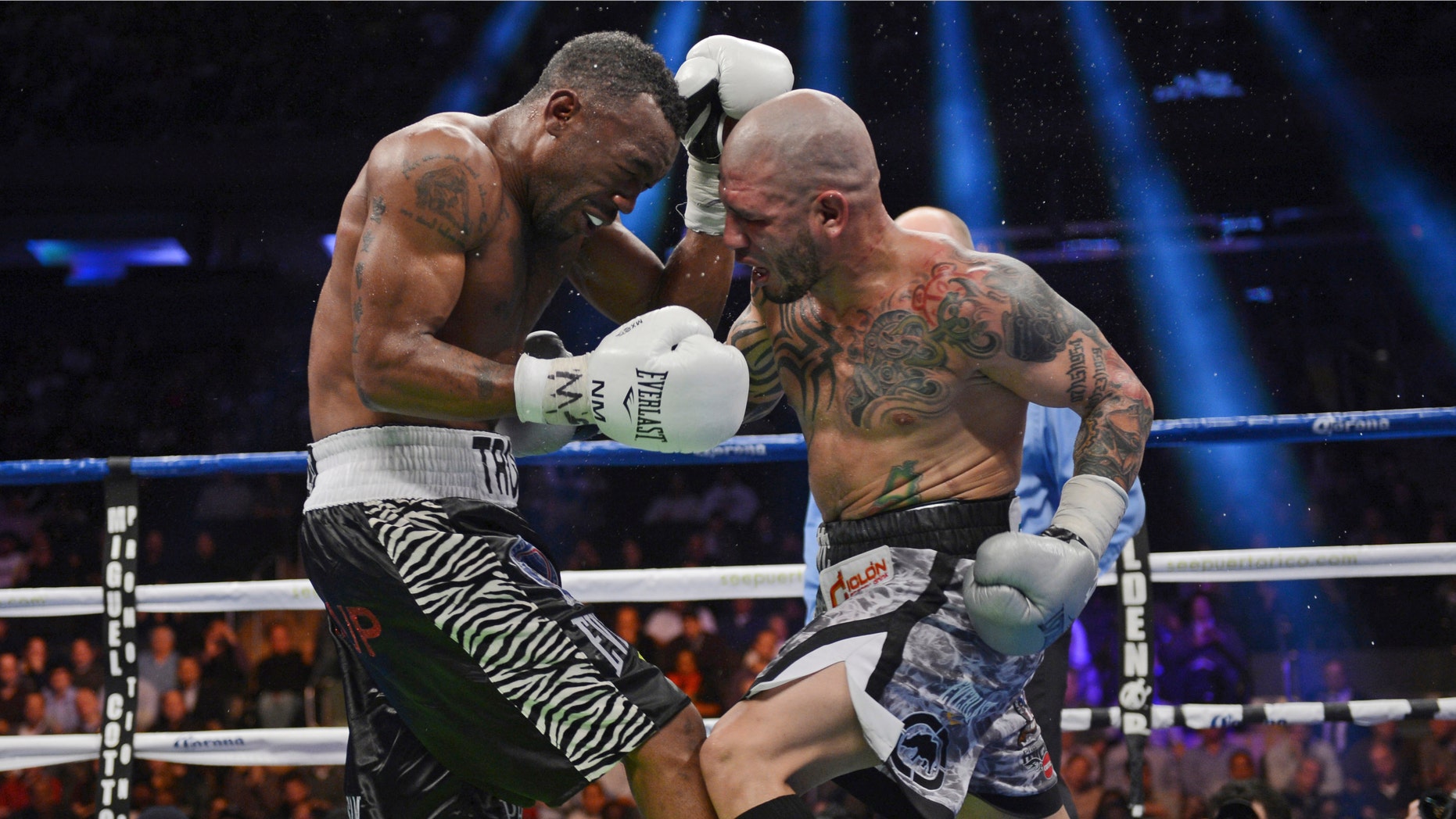 Austin Trout, left, and Miguel Cotto of Puerto Rico face off in the 11th round of their WBA super welterweight title fight at Madison Square Garden in New York, Saturday, Dec. 1, 2012. Trout won the 12-round boxing match in a unanimous decision. (AP Photo/Henny Ray Abrams)