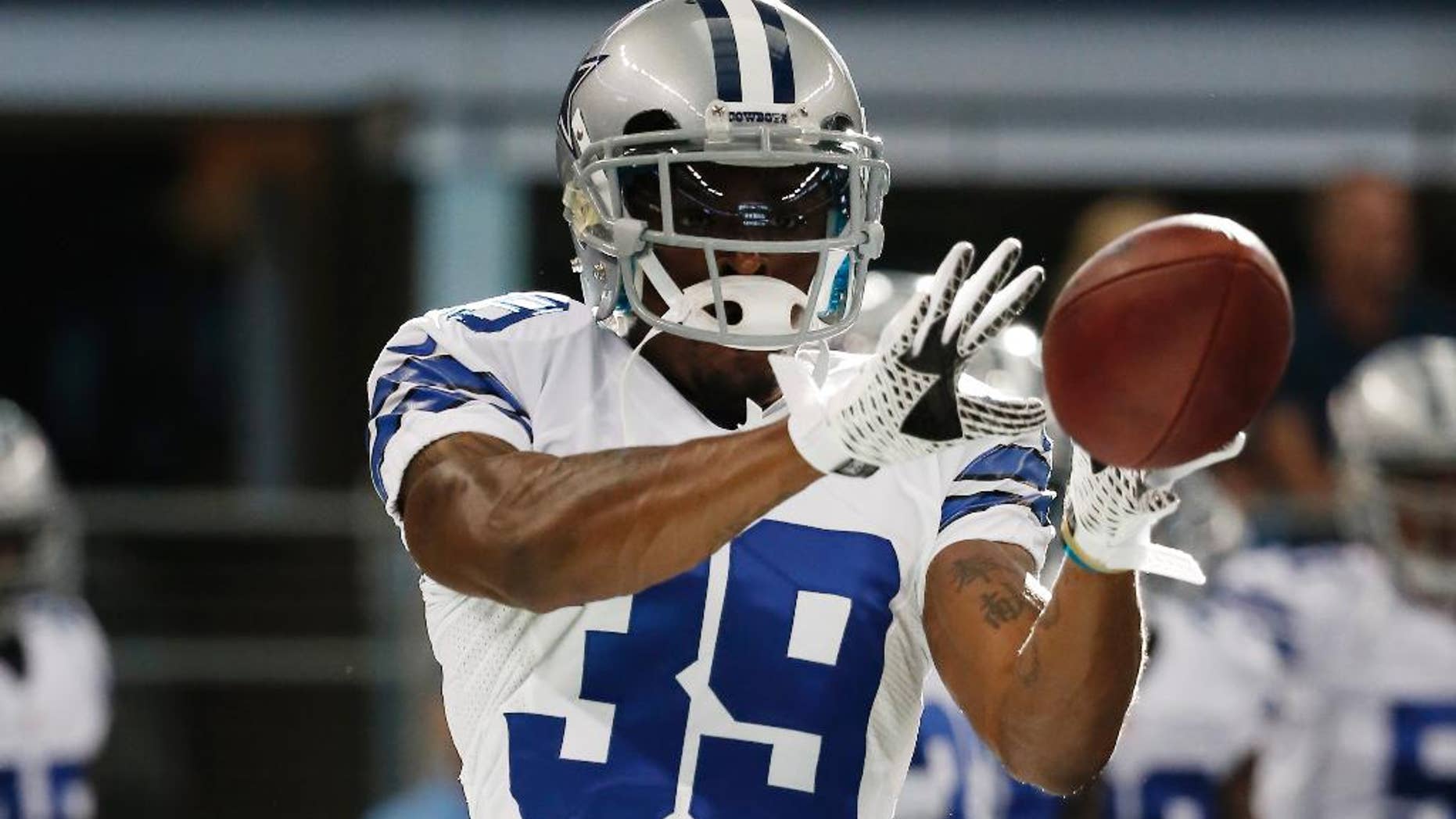 FILE - In this Aug. 28, 2014, file photo, Dallas Cowboys cornerback Brandon Carr warms up before an NFL preseason football game against the Denver Broncos in Arlington, Texas. Carr has closed off his world to just about anything that isn't football or family. The Dallas cornerback says it has a lot to do with losing his mom to breast cancer during training camp, and maybe it's a little bit about his team's surprisingly fast start. (AP Photo/Brandon Wade, File)