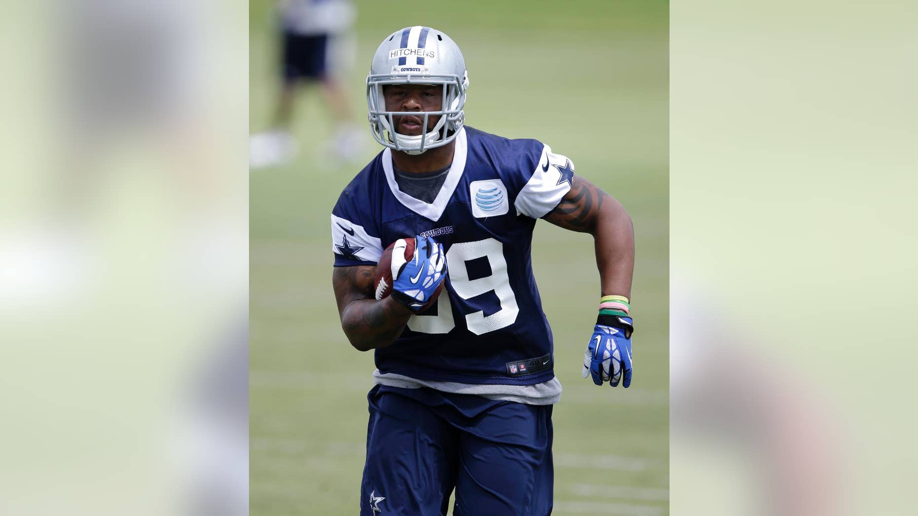 Dallas Cowboys linebacker Anthony Hitchens carries the ball in a drill during an NFL football organized team activity, Monday, June 2, 2014, in Irving, Texas. (AP Photo/Tony Gutierrez)