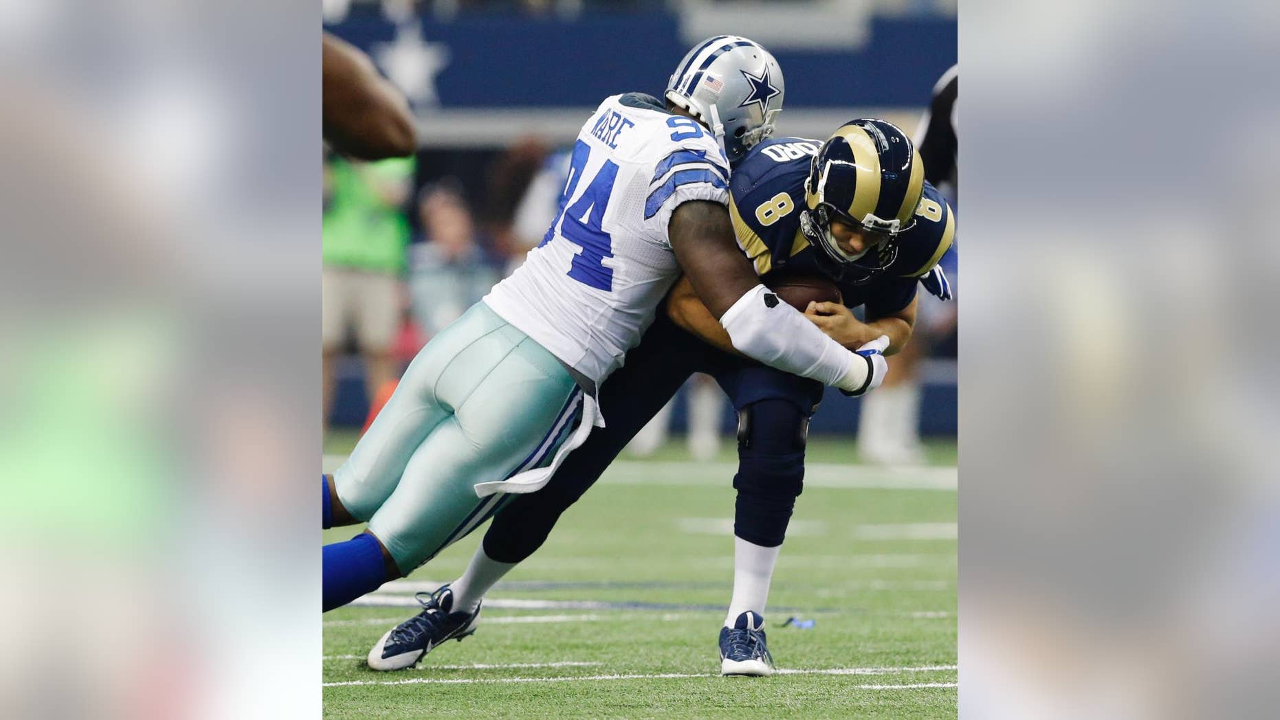File - In this Sept. 22, 2013, file photo, Dallas Cowboys defensive end DeMarcus Ware (94) sacks St. Louis Rams quarterback Sam Bradford (8) during the third quarter of an NFL football game, in Arlington, Texas. The Cowboys are releasing franchise sacks leader Ware to save salary cap room after the worst season of his career. (AP Photo/LM Otero, File)