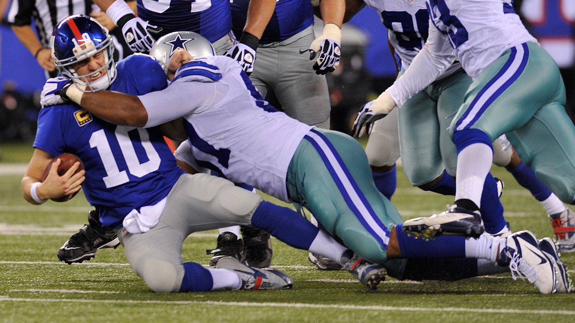 Sept. 5, 2012: New York Giants quarterback Eli Manning (10) is sacked by Dallas Cowboys defensive end Jason Hatcher (97) during the second half of an NFL football game.