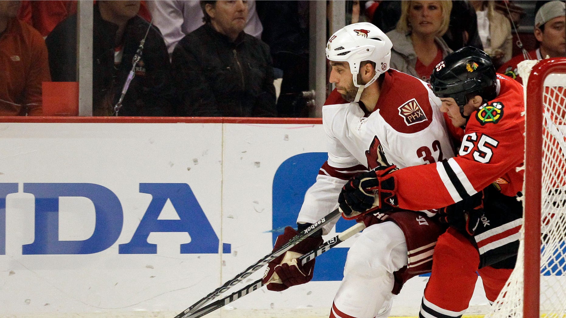 Phoenix Coyotes' Michal Rozsival (32) controls the puck against Chicago Blackhawks' Andrew Shaw (65) during the second period of Game 6 of an NHL hockey Stanley Cup first-round playoff series in Chicago, Monday, April 23, 2012. (AP Photo/Nam Y. Huh)