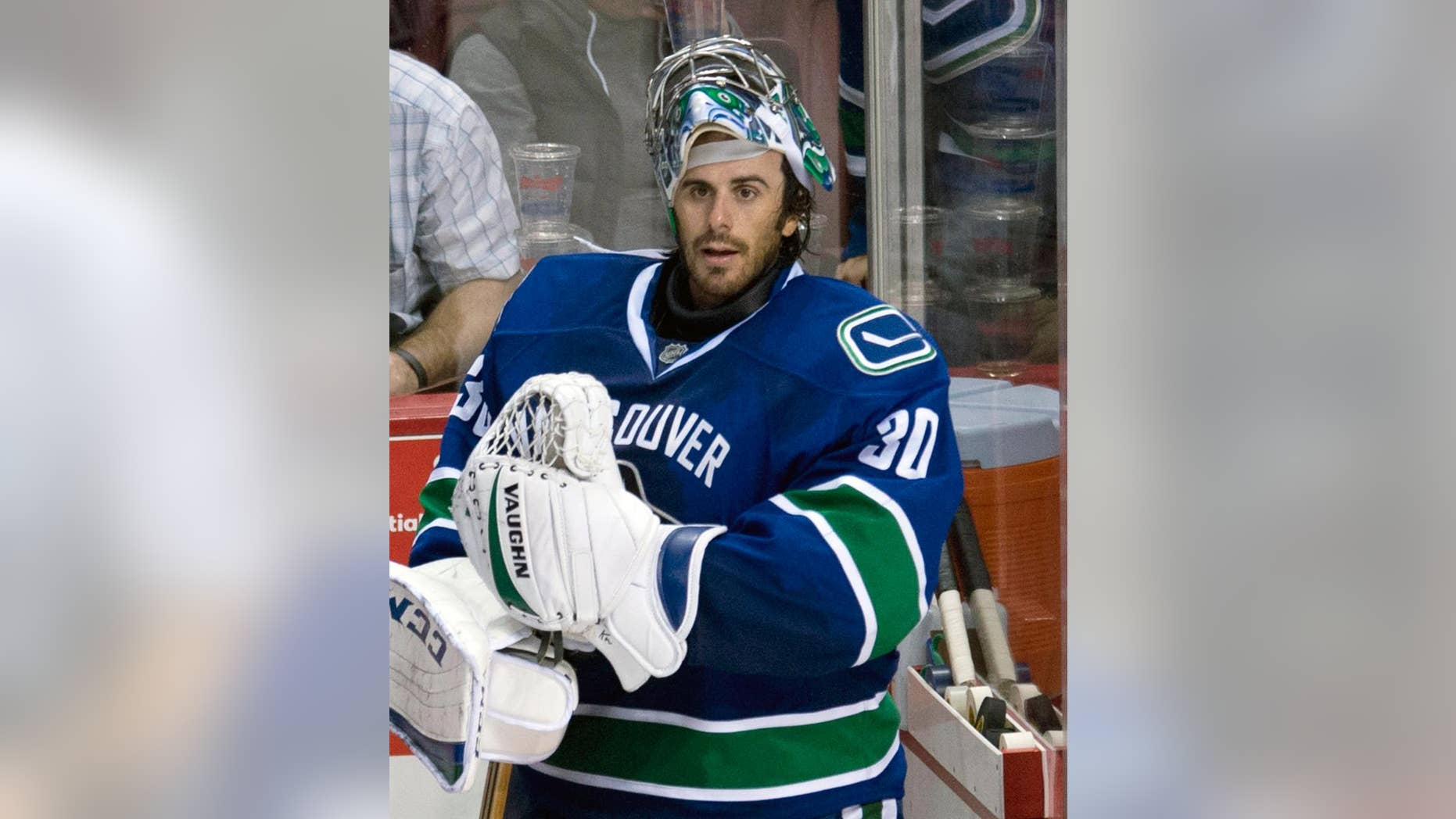 Vancouver Canucks goalie Ryan Miller prepares to leave the bench following the Canucks loss to the Arizona Coyotes in Vancouver, British Columbia, Monday, Sept. 29, 2014. (AP Photo/The Canadian Press, Jonathan Hayward)