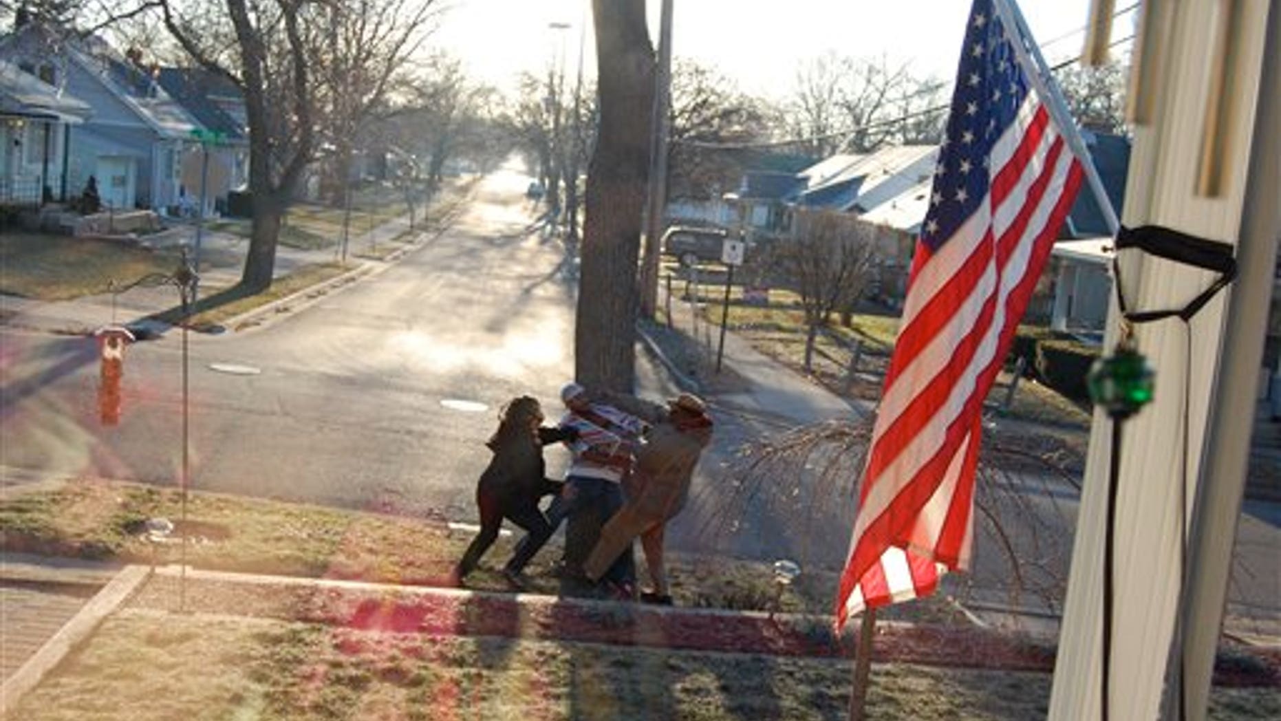 In this Thursday, March 31 photo taken by an unidentified witness, crossing guard James Thompson, 73, is attacked by two suspects in Lansing, Michigan.
